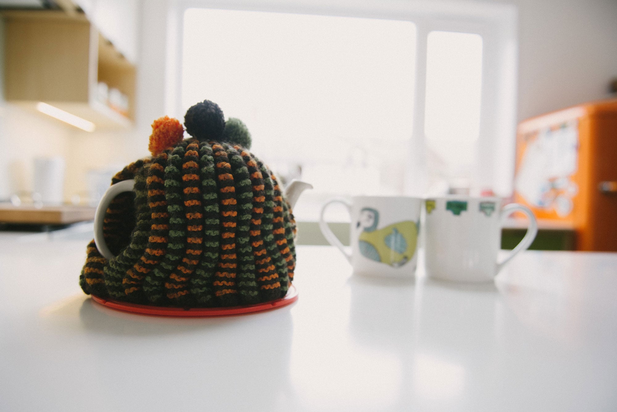 Green and orange tea cosy