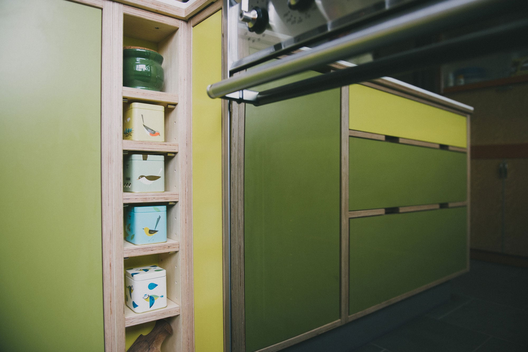 Green and yellow plywood kitchen - spice rack
