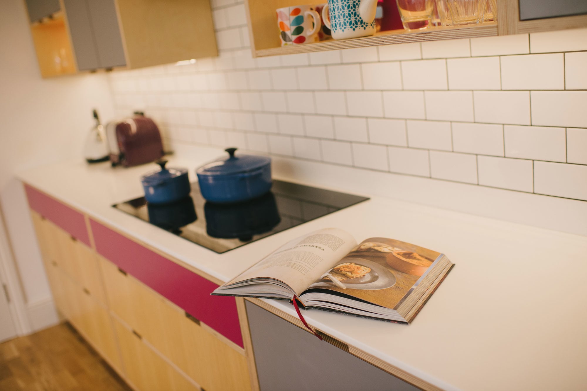 Corian worktop of pink and grey kitchen