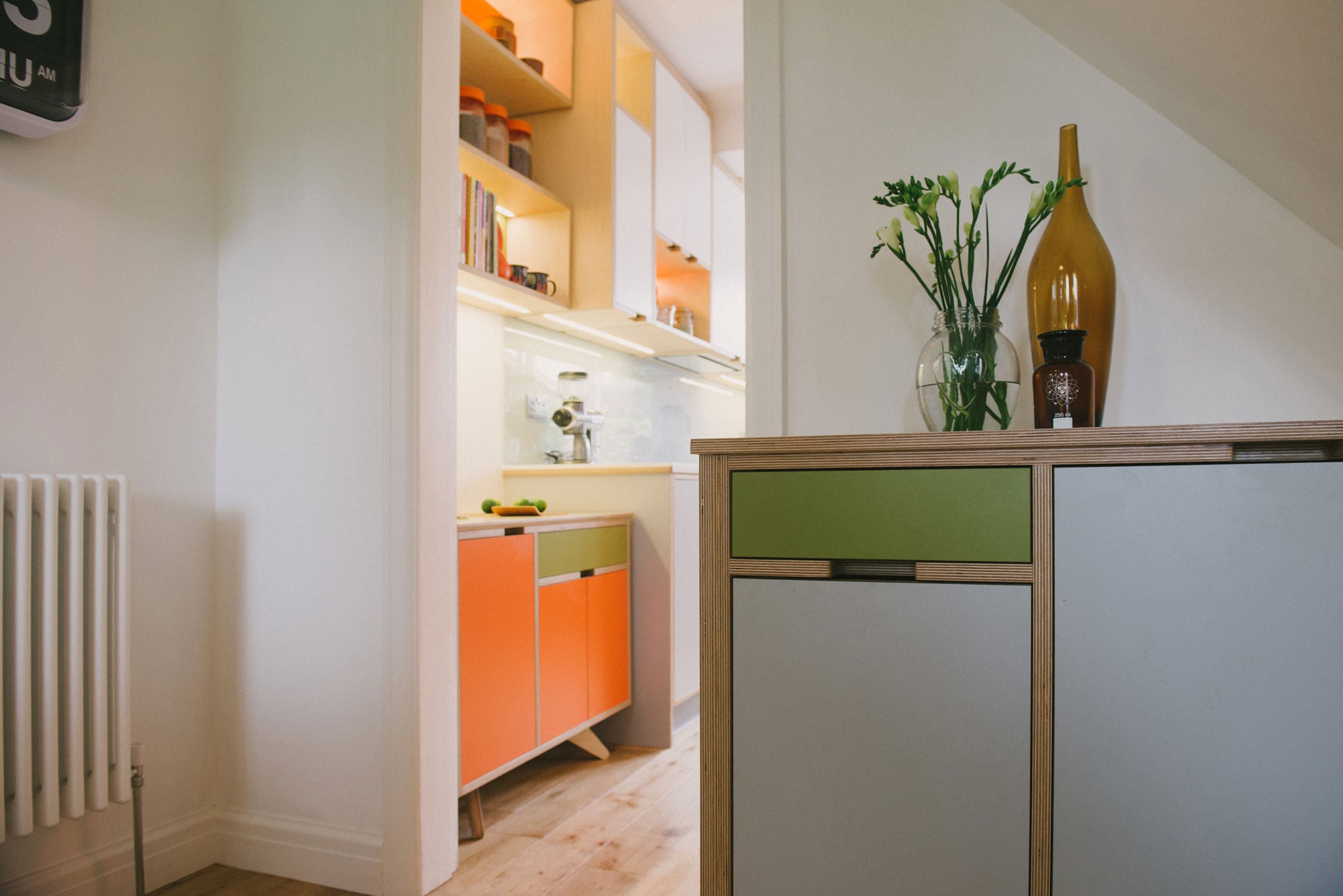 Orange & green plywood kitchen