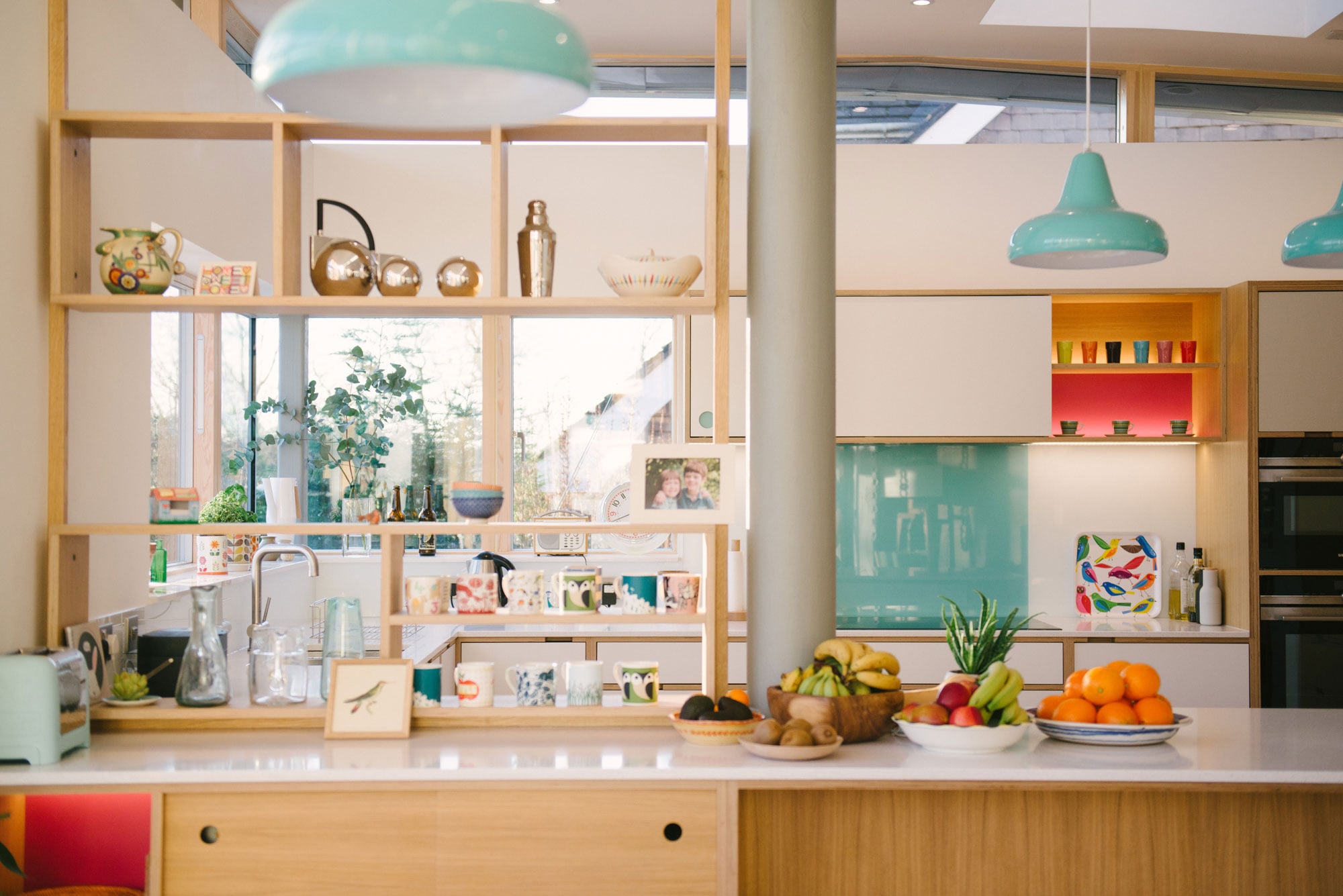 Open Shelving Defines Space Between Kitchen and Living Area
