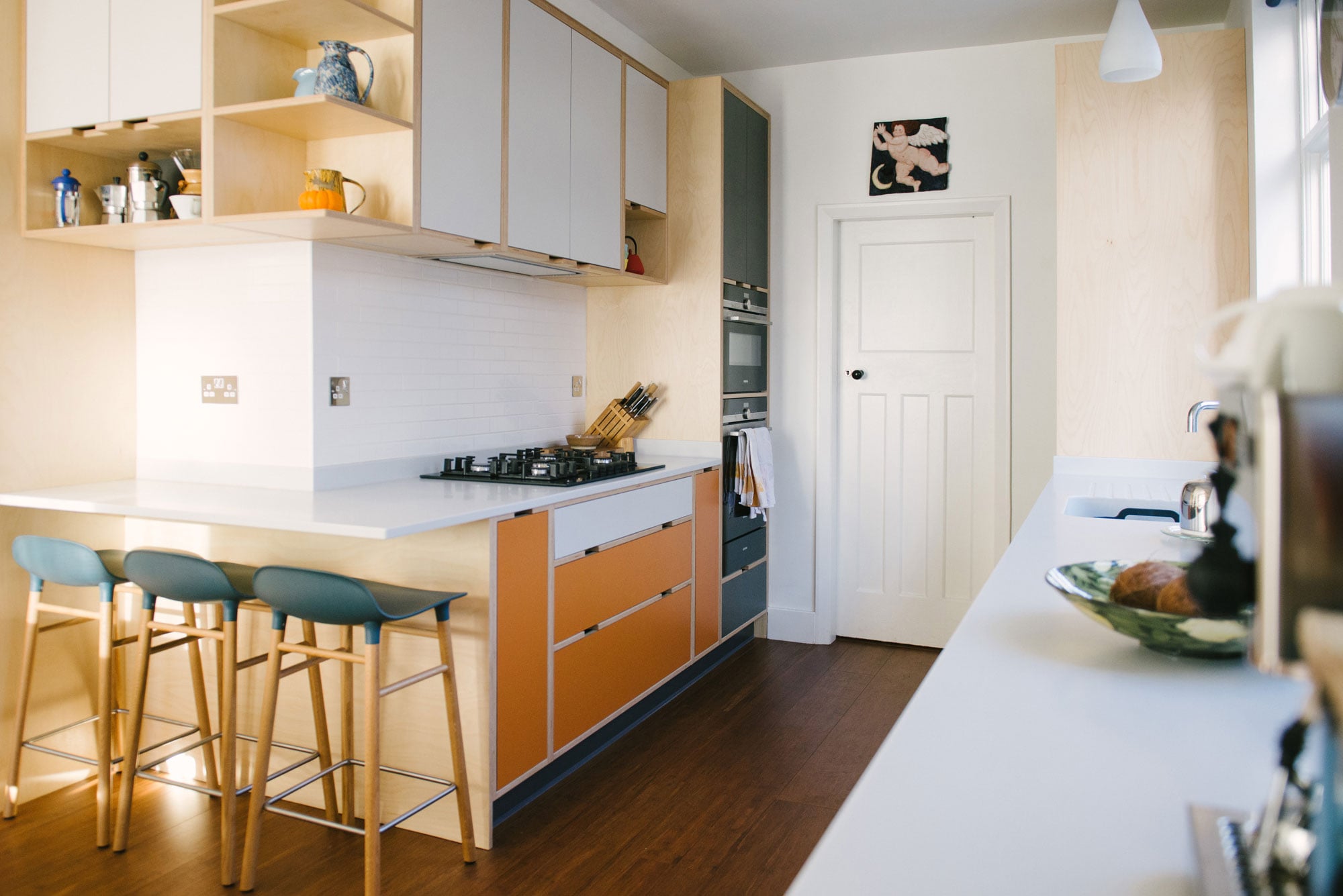 Cooking Area of Orange and White Laminated Plywood Kitchen
