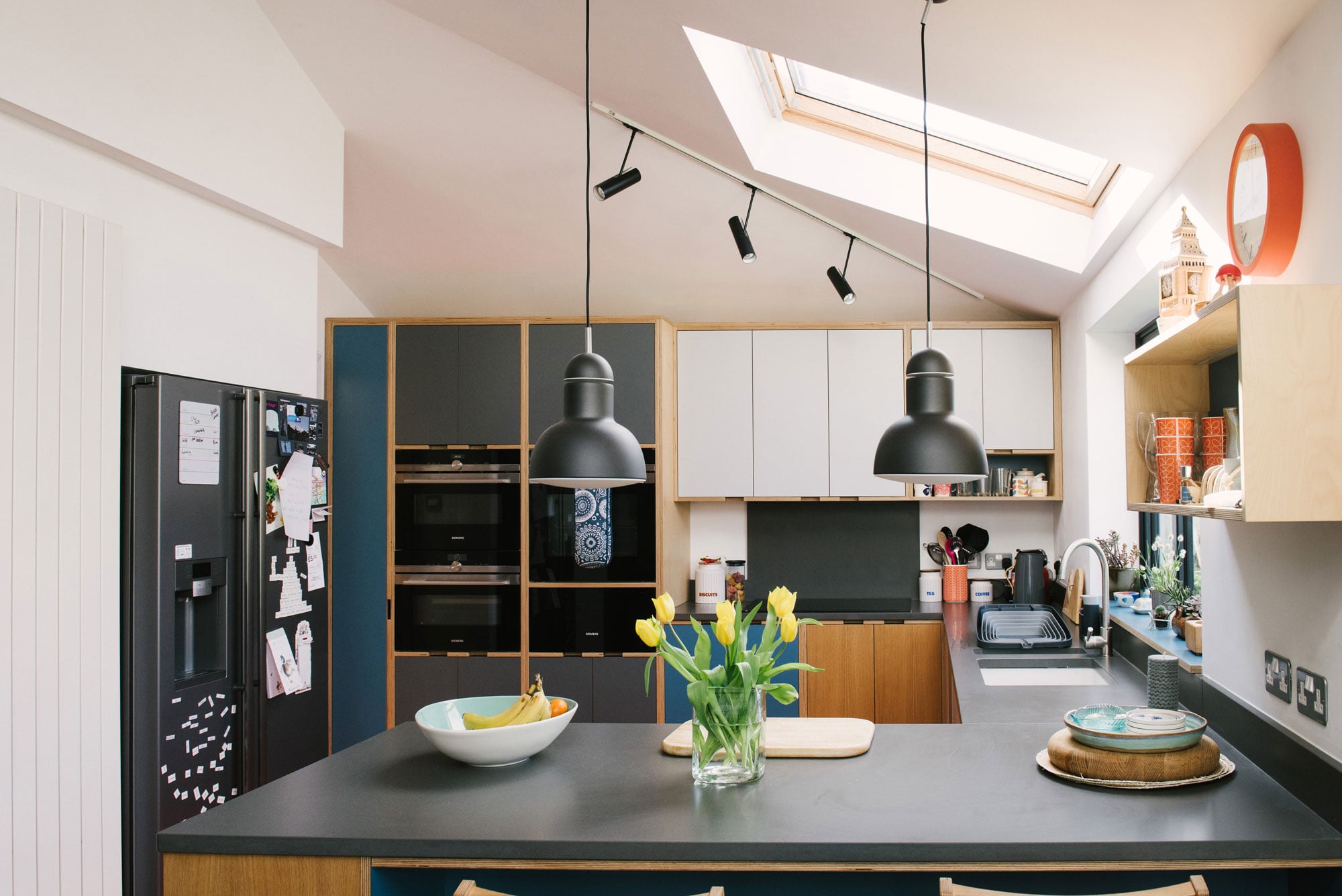 Fridge area of Plywood Kitchen With Orange Floor