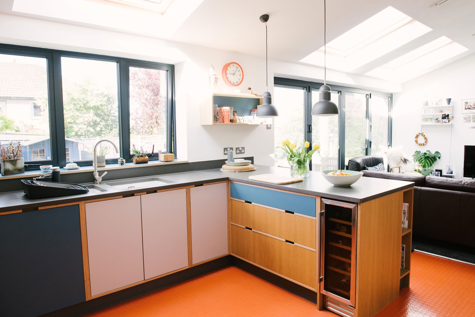 Plywood Kitchen With Orange Floor Showing Wine Fridge