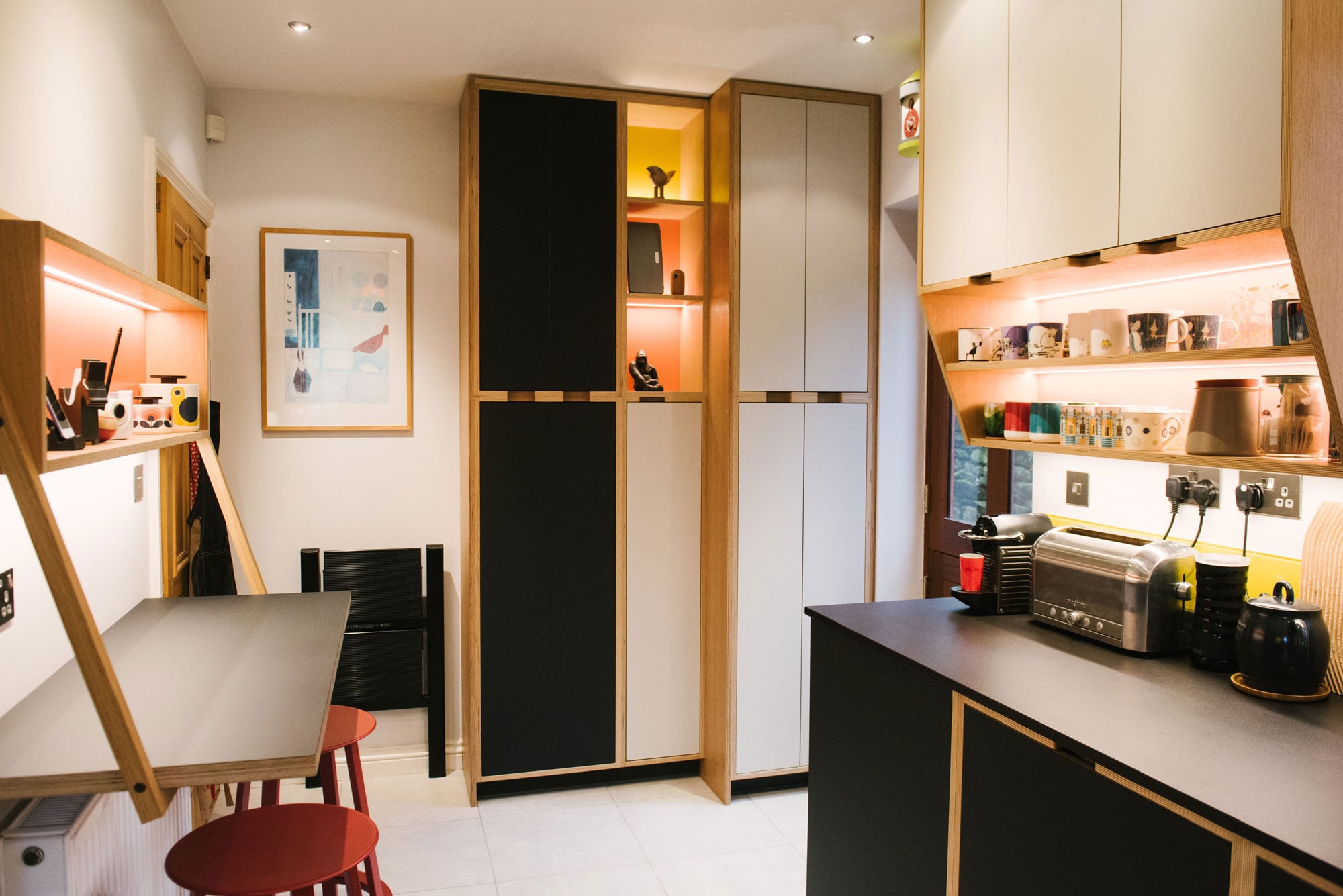 Breakfast Bar of Black Plywood Kitchen with Yellow Splashback