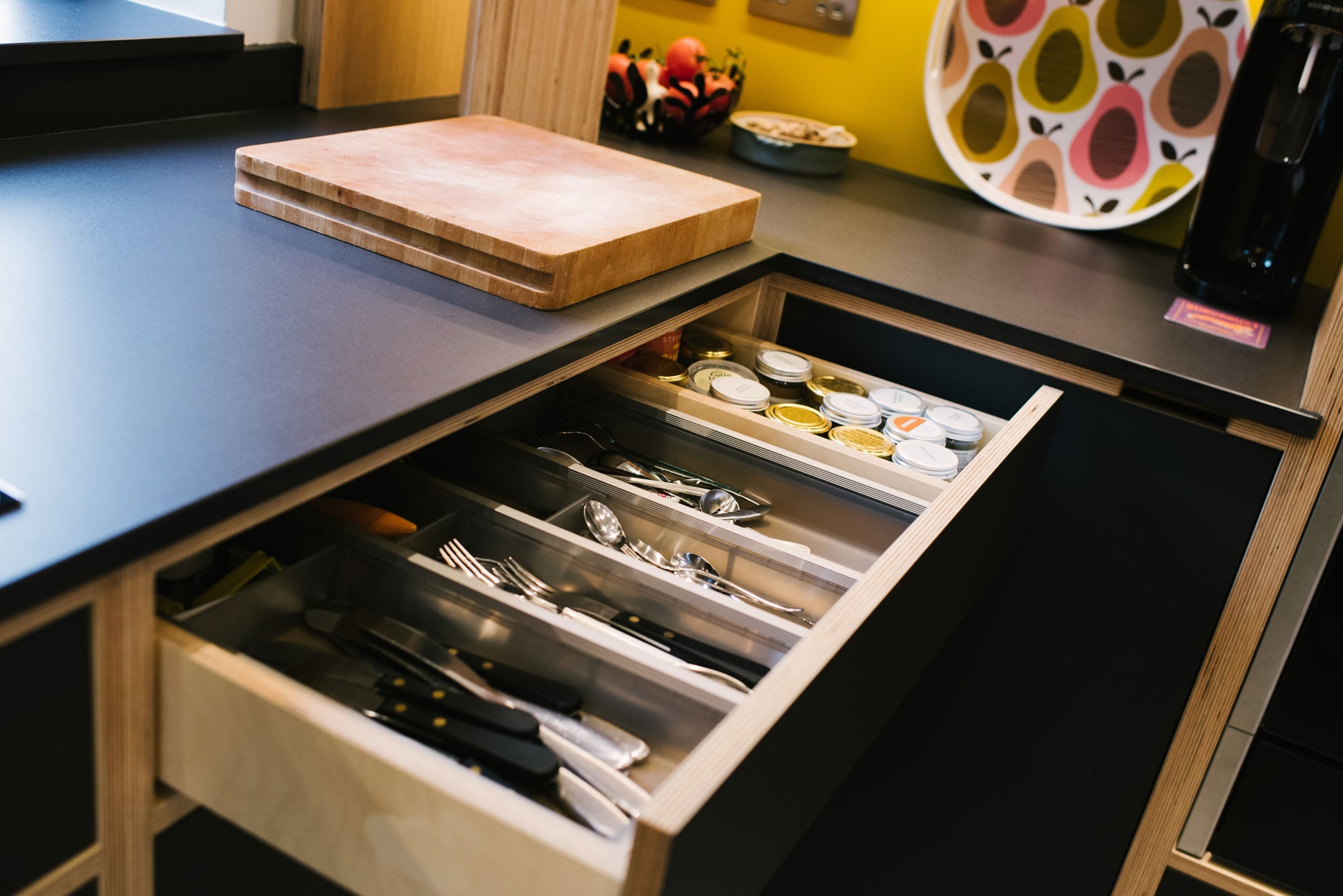 Cutlery Drawer of Black Plywood Kitchen with Yellow Splashback