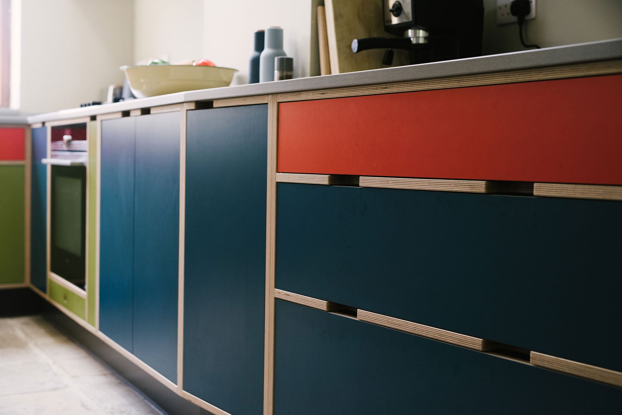 Handleless Drawer Unit in Green Orange & Blue Plywood Kitchen