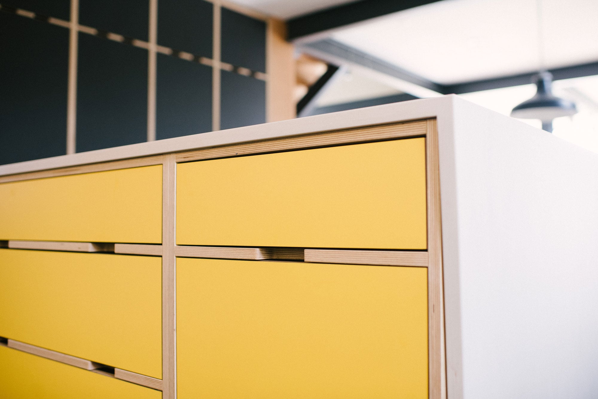 Yellow plywood kitchen drawers