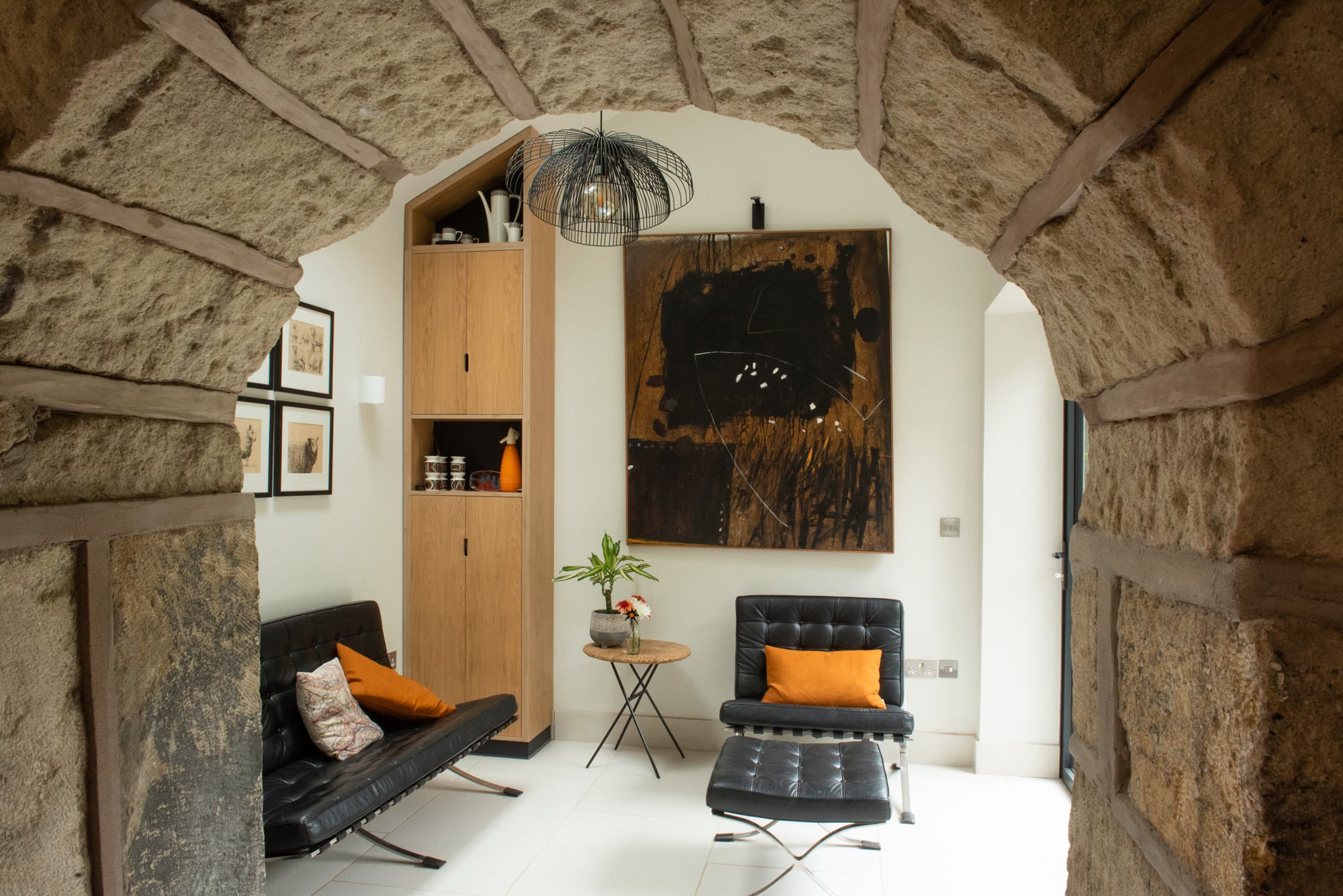 view of bespoke furniture through stone arch