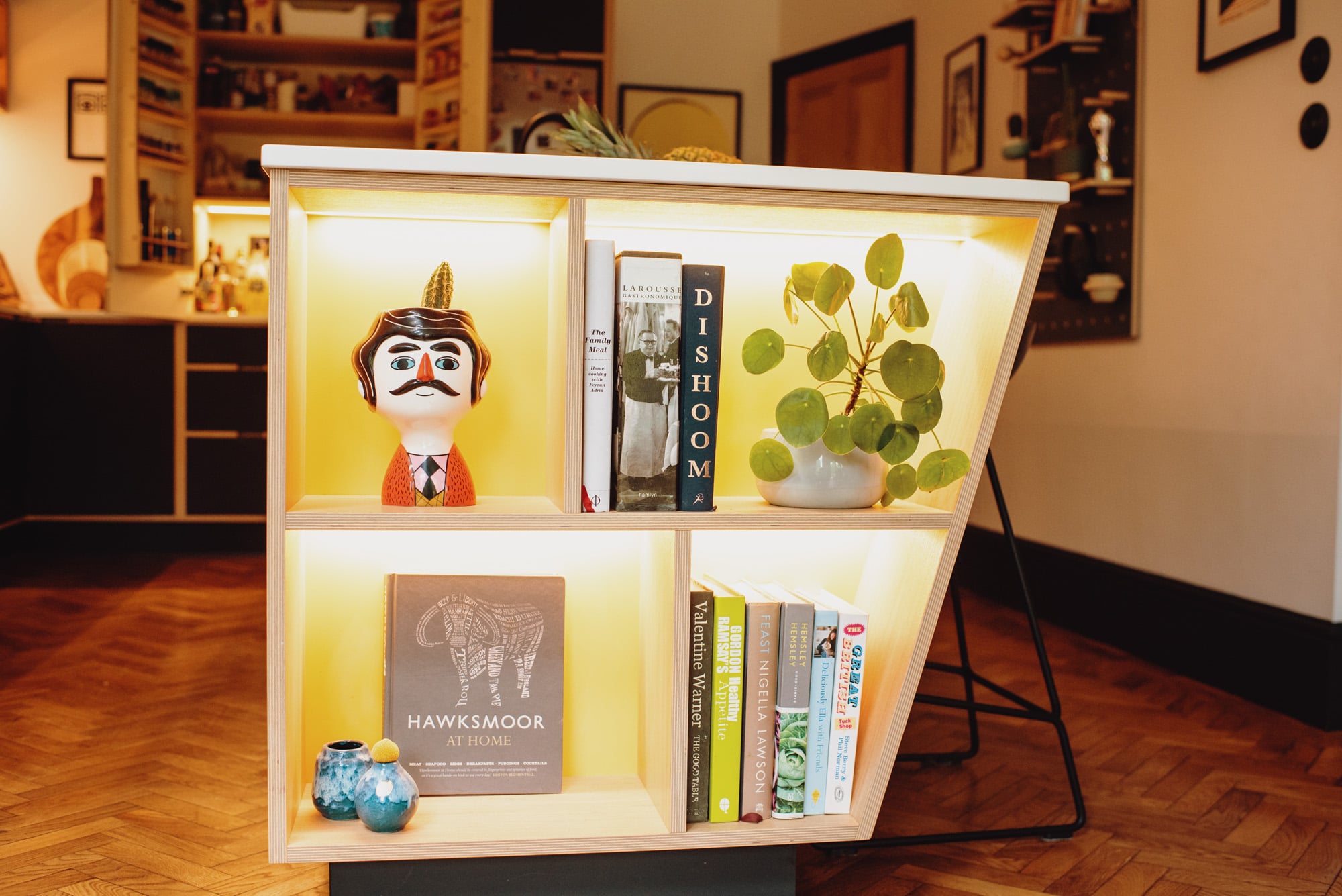 Sie view of illuminated yellow plywood kitchen island