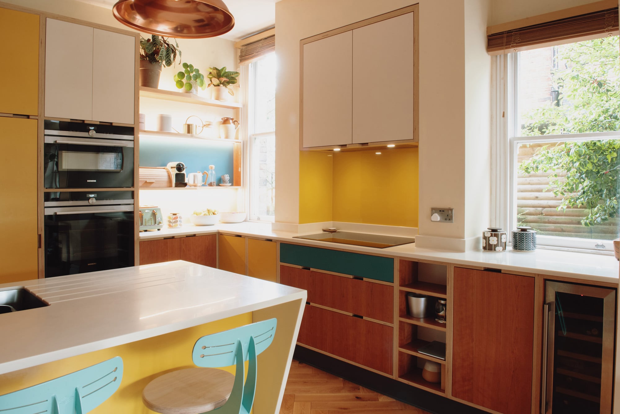 cherry kitchen hob area with yellow glass splash back