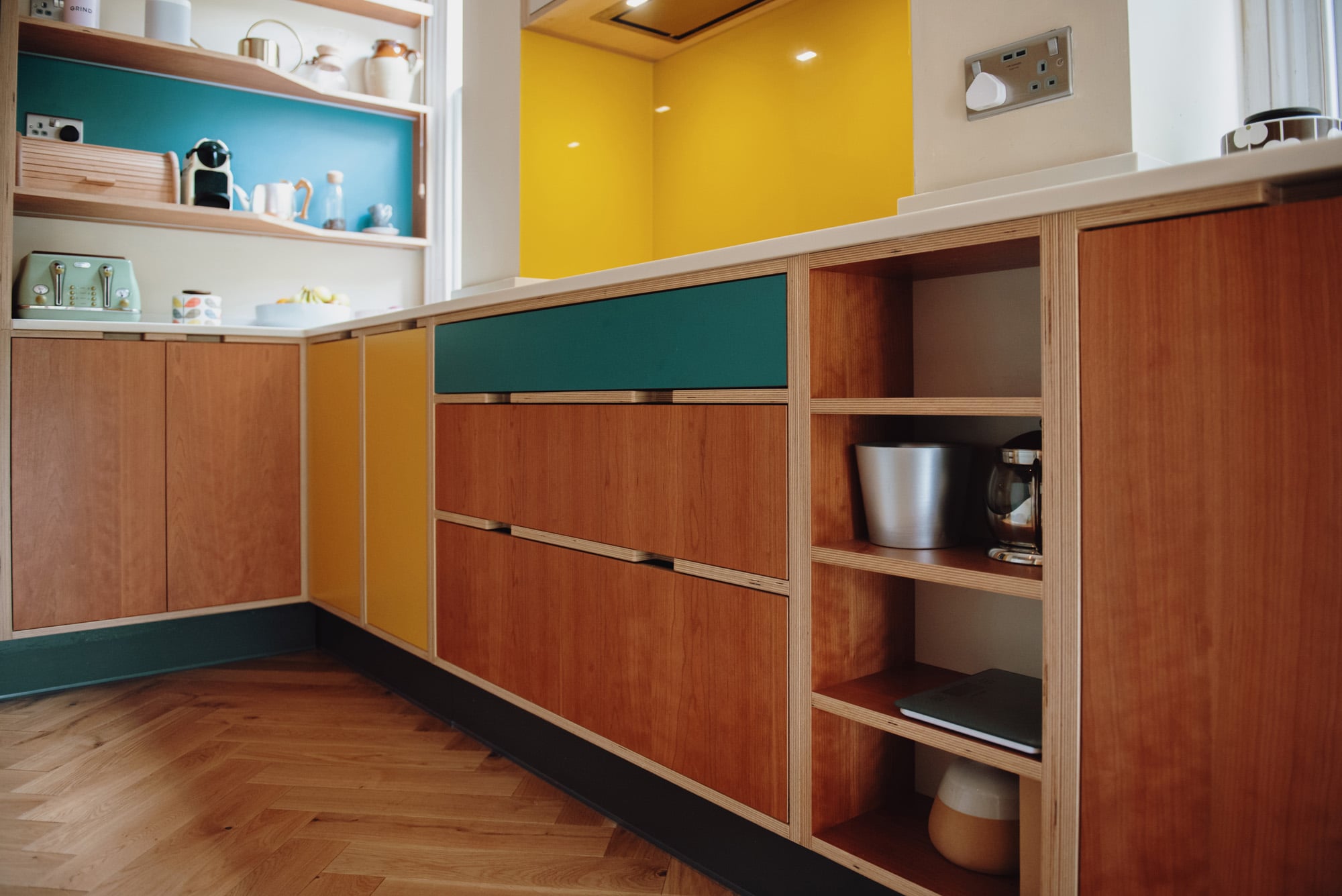 cherry kitchen drawer units with open shelving and yellow splash back  