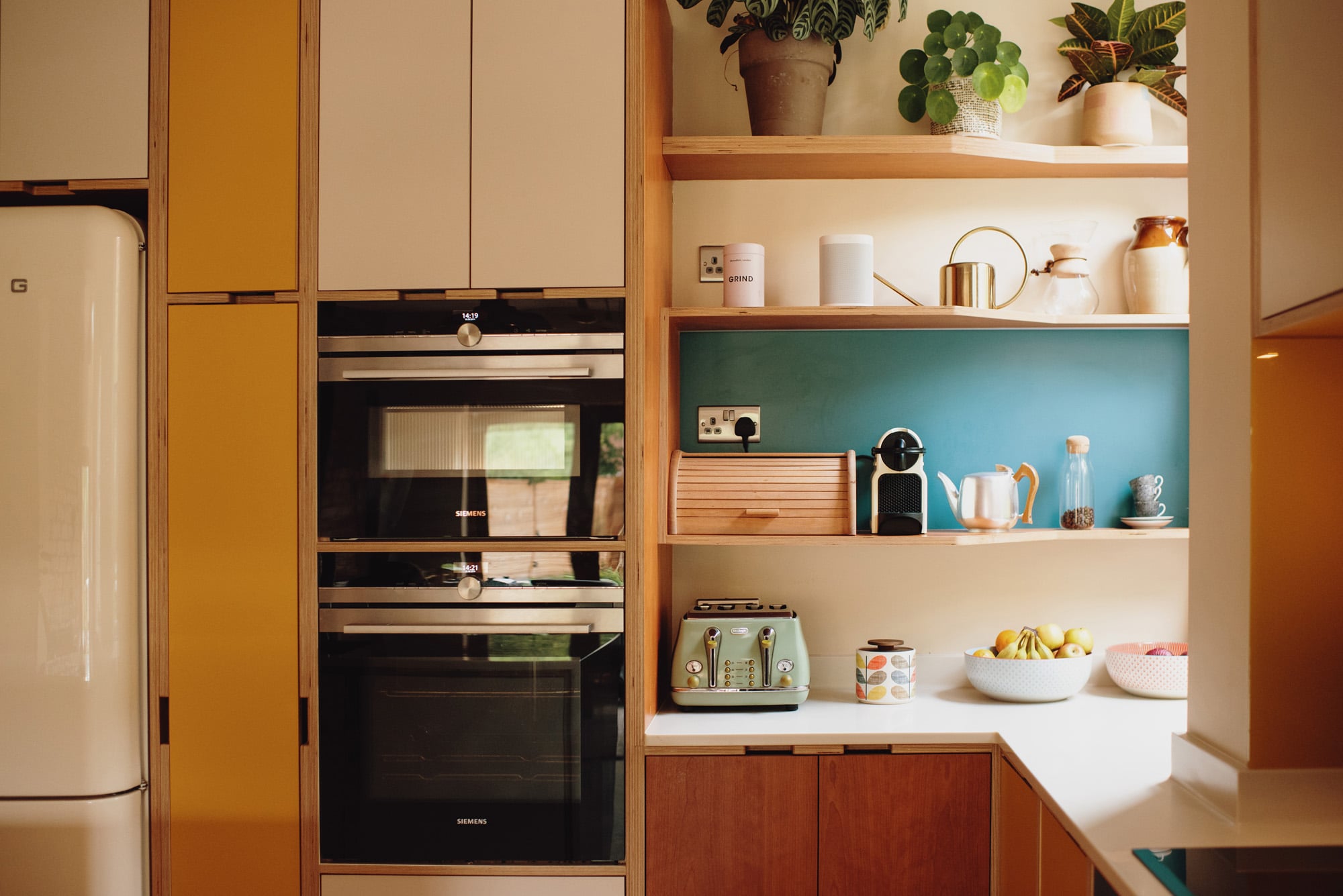 cherry kitchen double oven and open shelving 