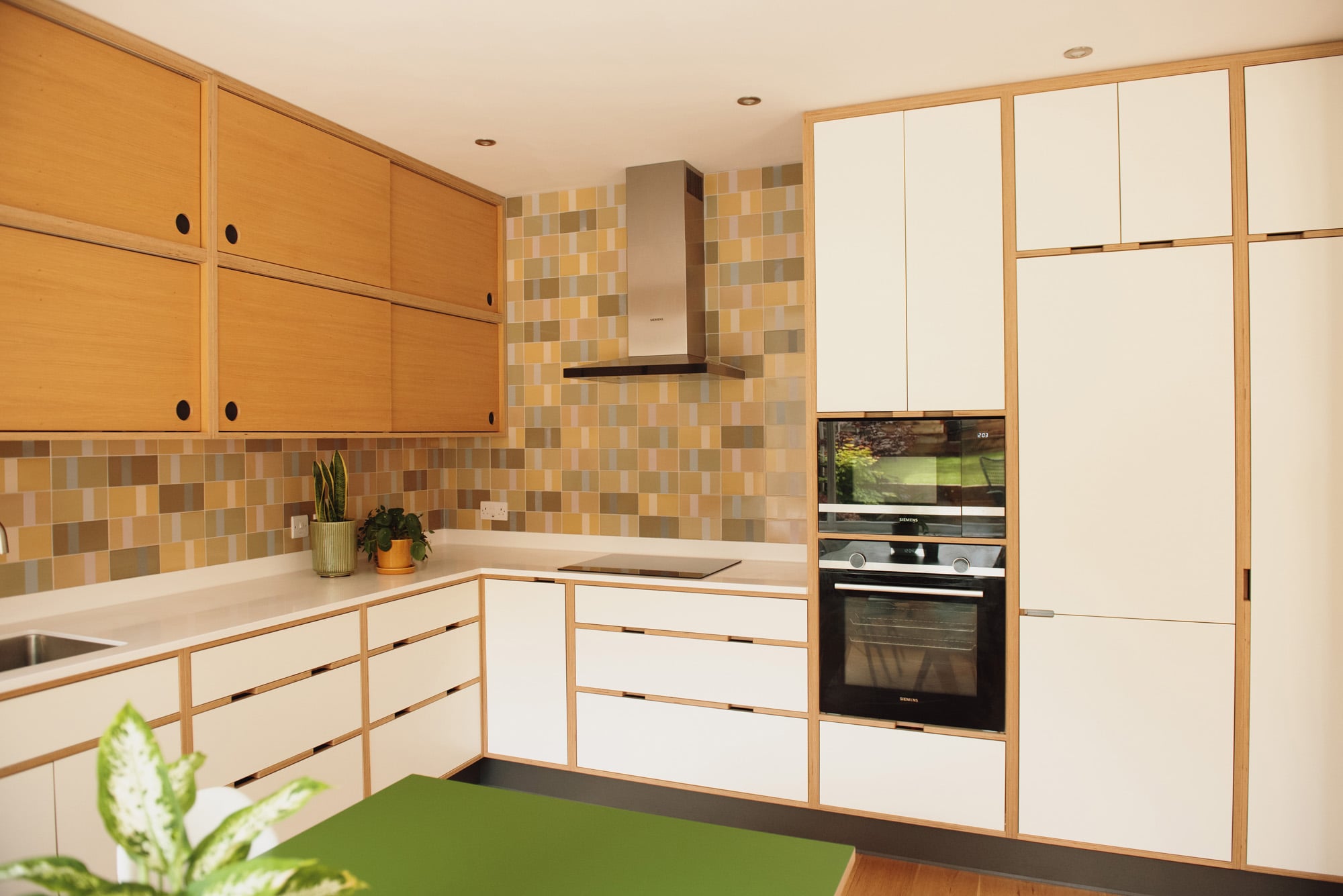 hob and oven area of white plywood kitchen
