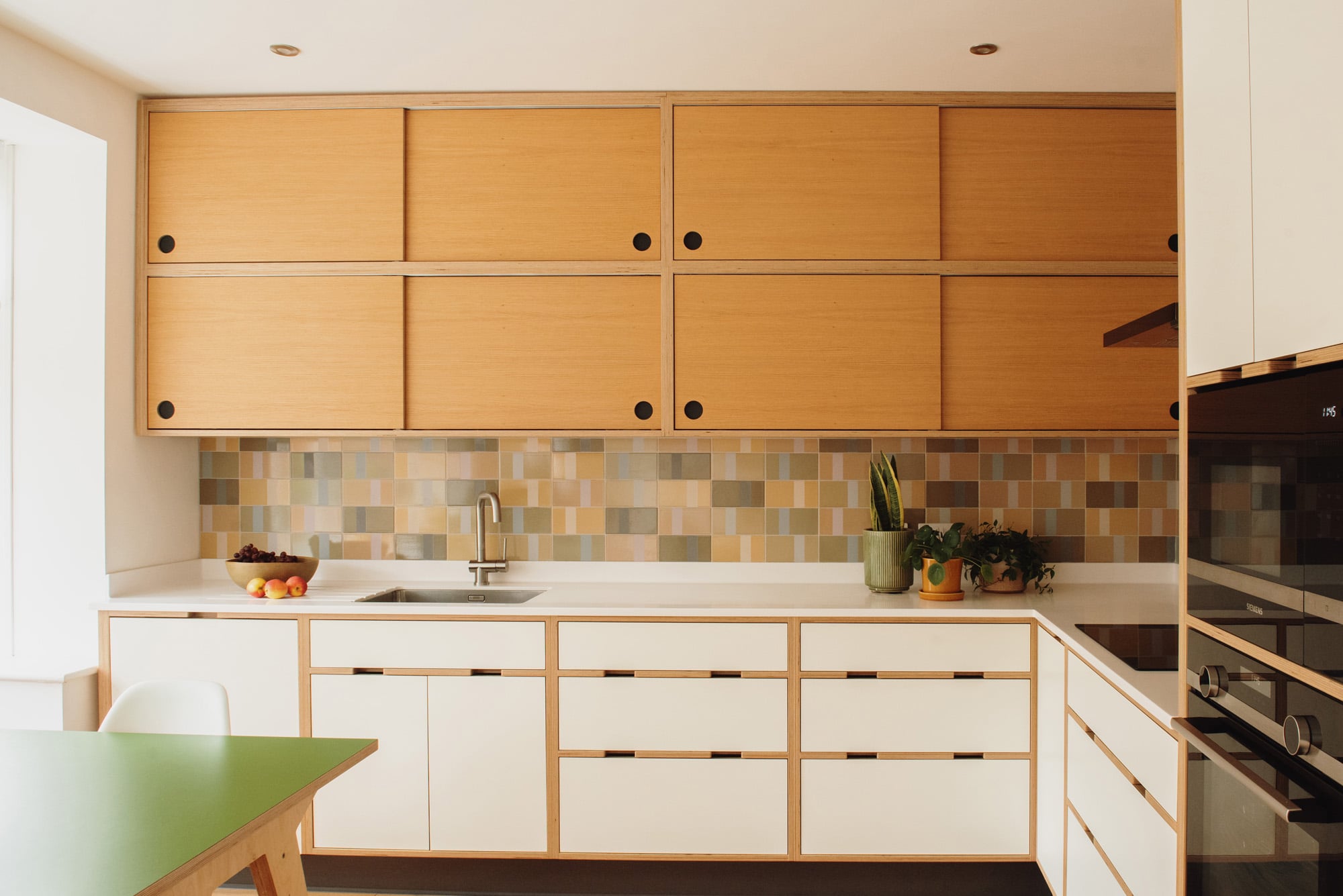 front view of white plywood kitchen with double layer oak wall units 