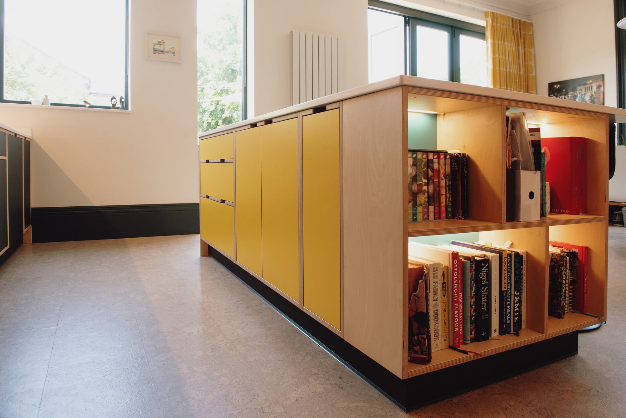 yellow kitchen island with open shelving 