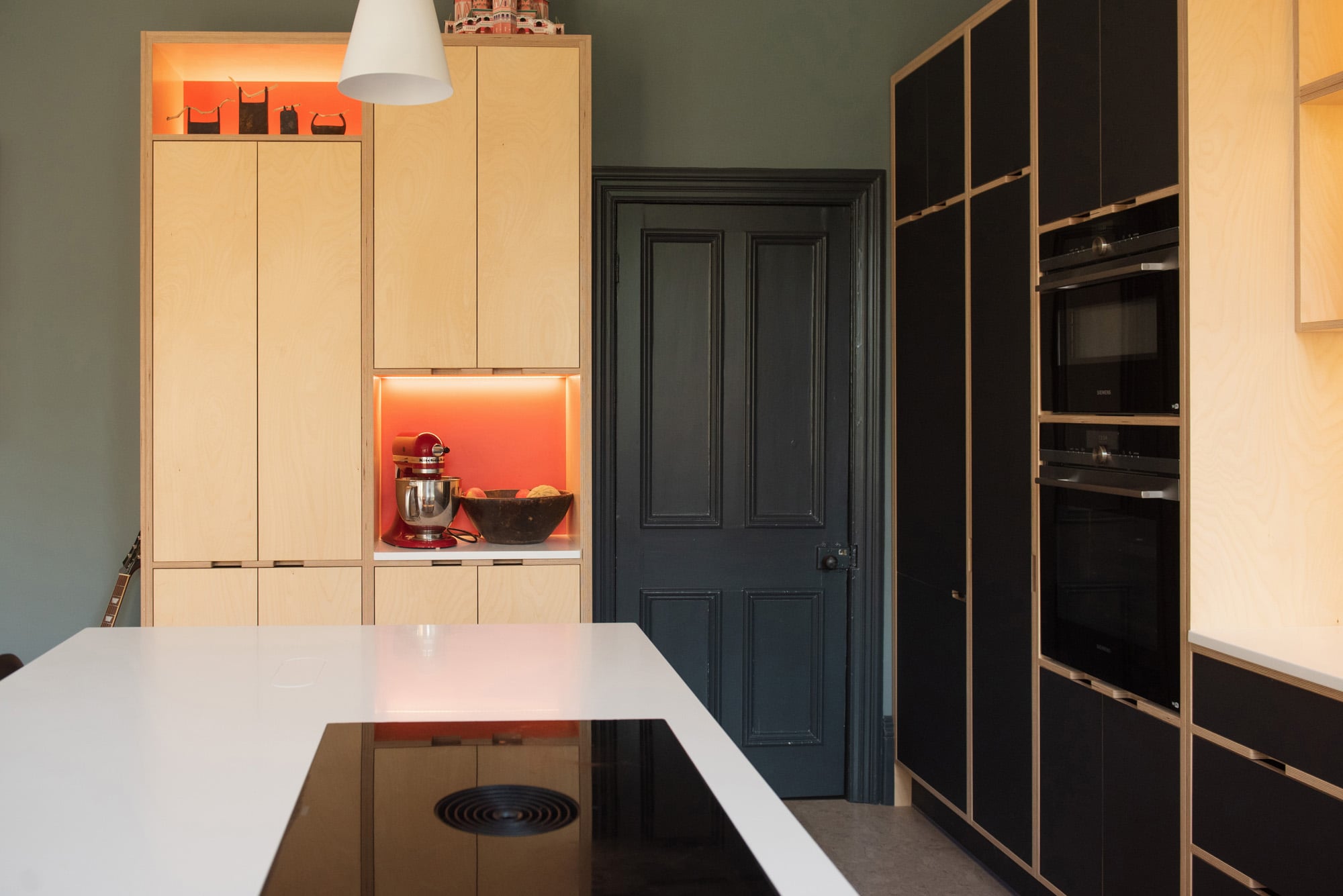 Bespoke kitchen with Bora hob and tall illuminated cabinets
