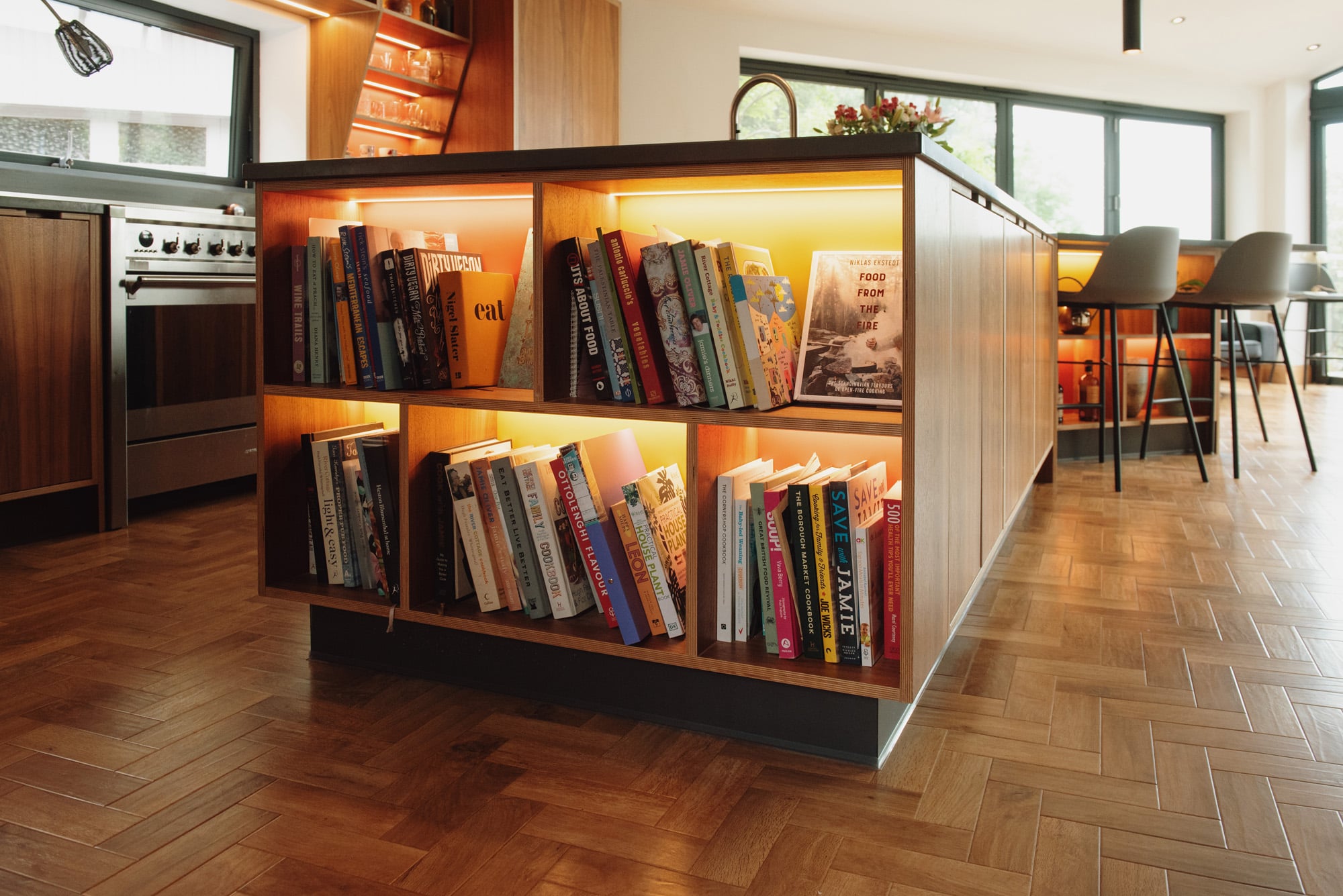 large island unit with illuminated bookshelf