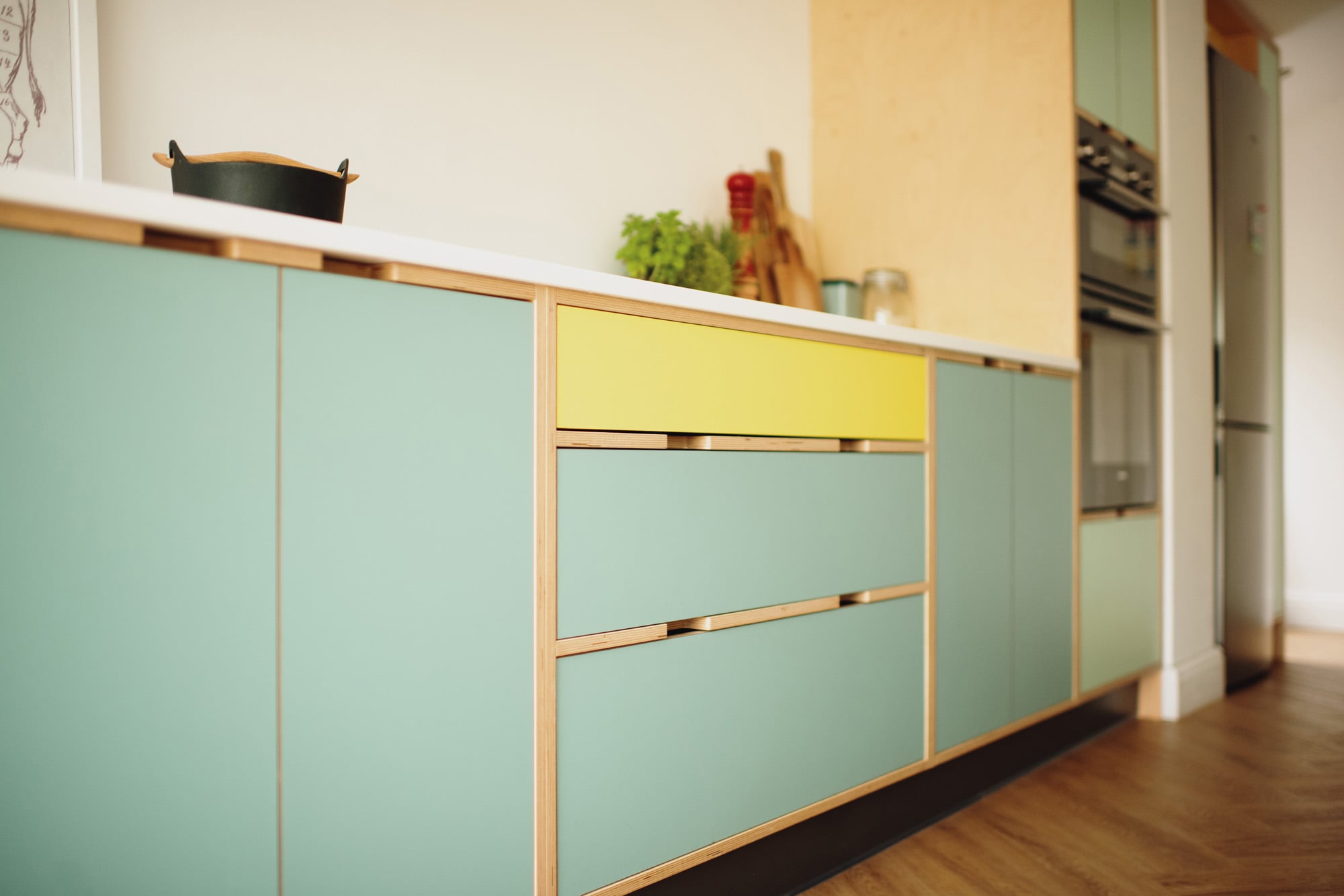 hob area of yellow and green plywood kitchen