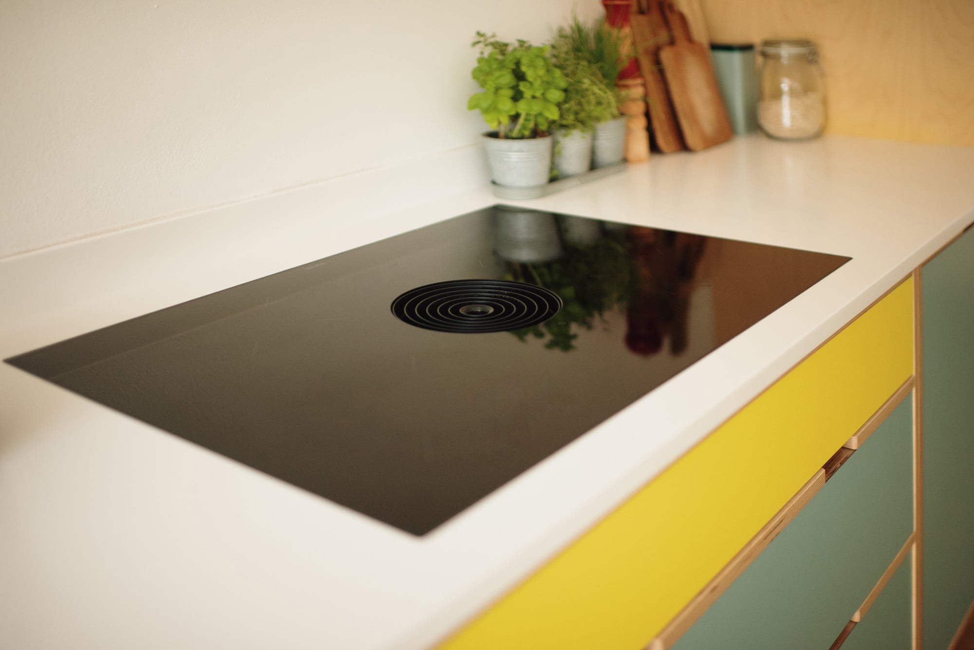 bora hob in yellow and green plywood kitchen