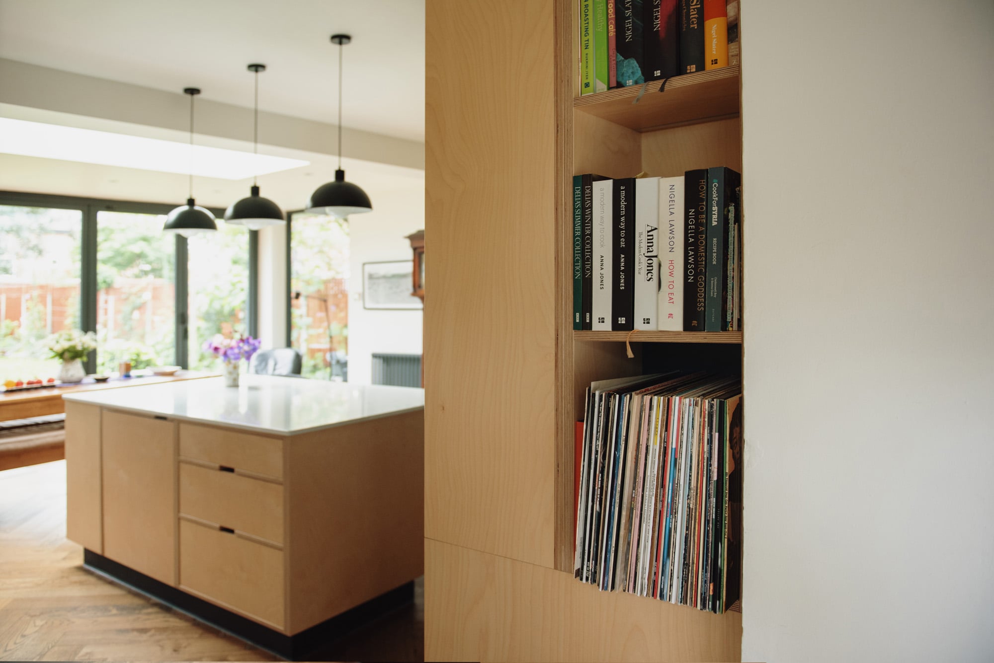 open plywood shelving between kitchen and utility
