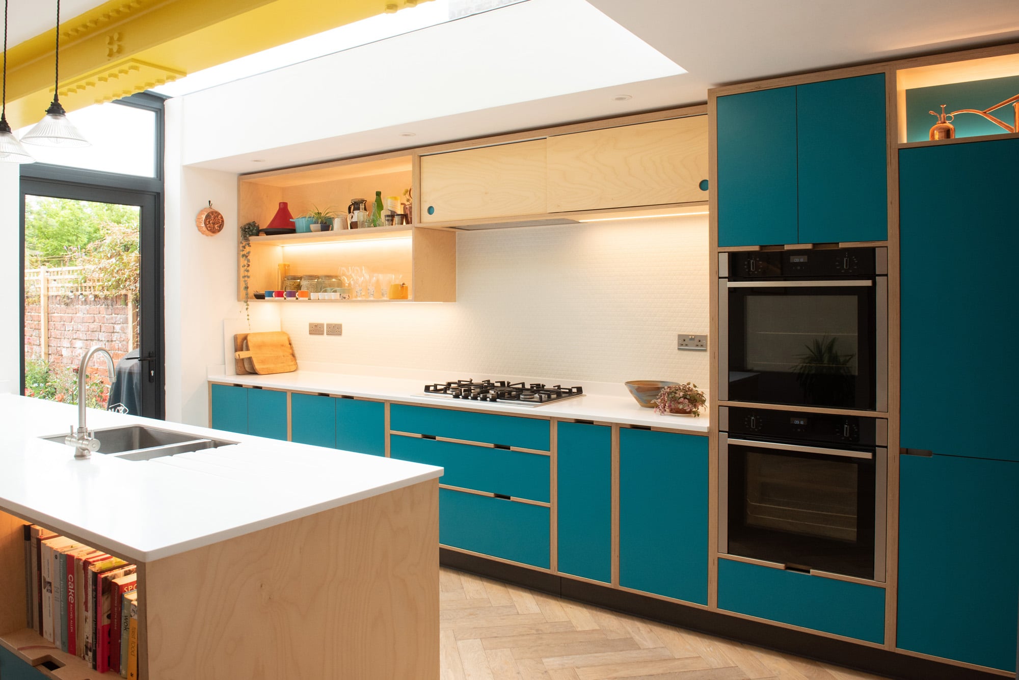 view of double oven in blue plywood kitchen 