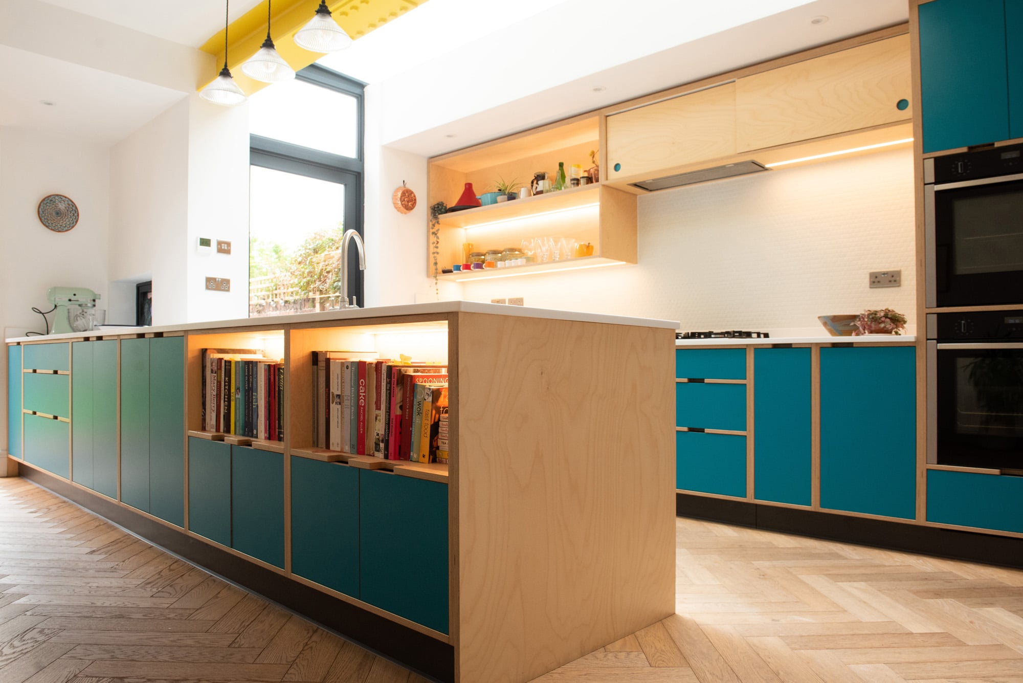 close shot of blue plywood kitchen cabinets