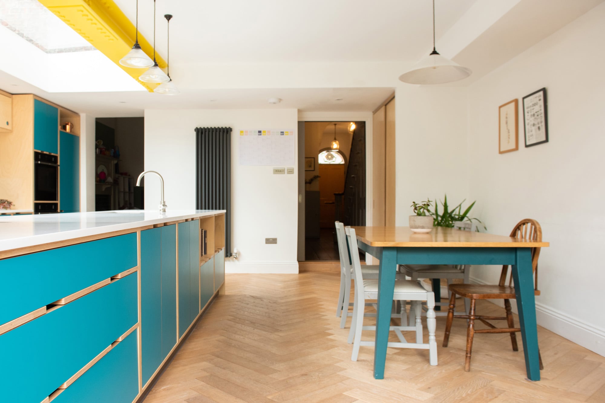 Blue laminate plywood kitchen with yellow I beam