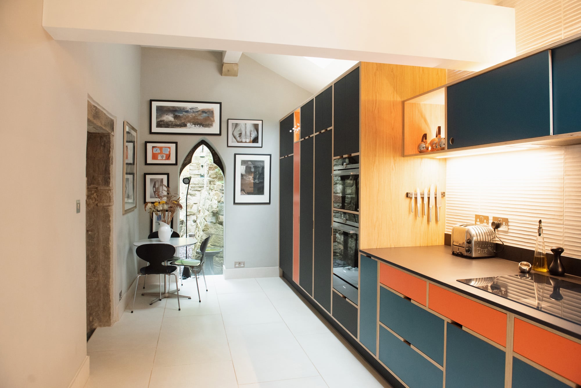 galley kitchen in orange and blue