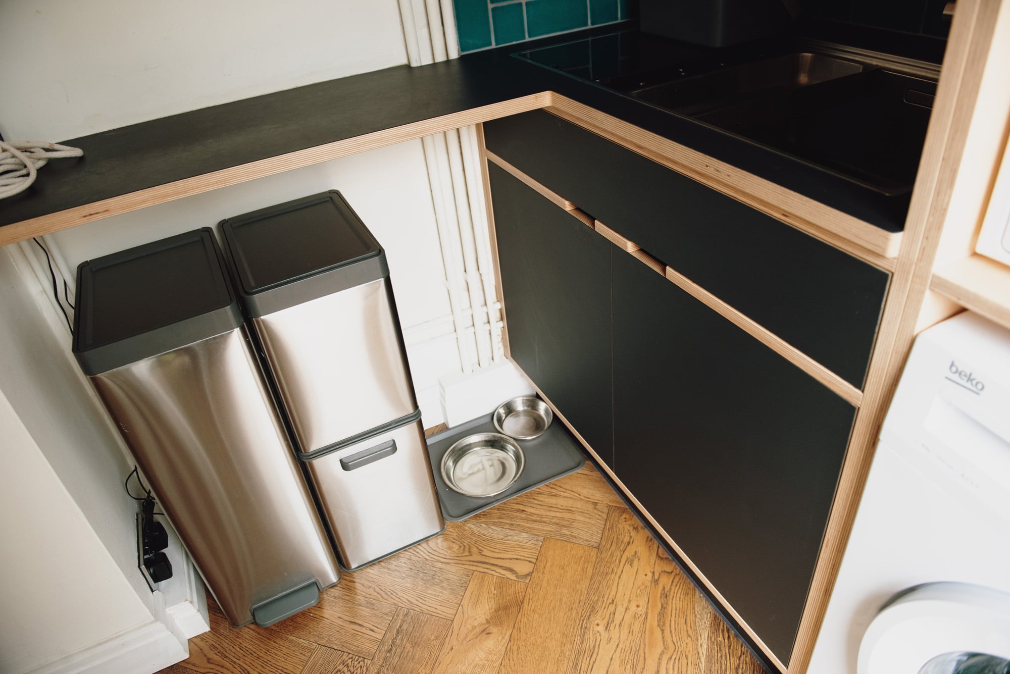 recycling bins and pet feeding bowls in utility
