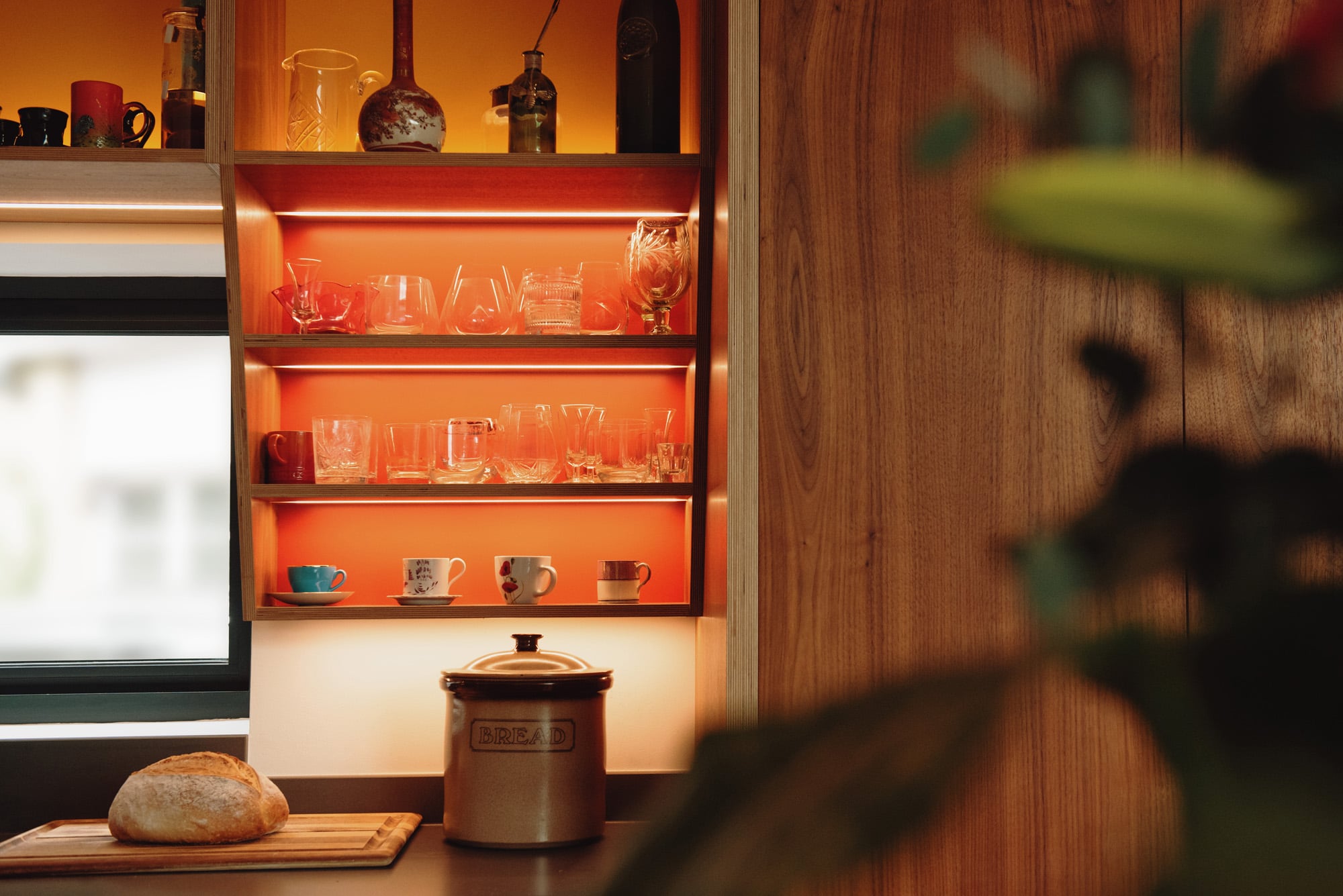illuminated kitchen shelving displaying glassware 