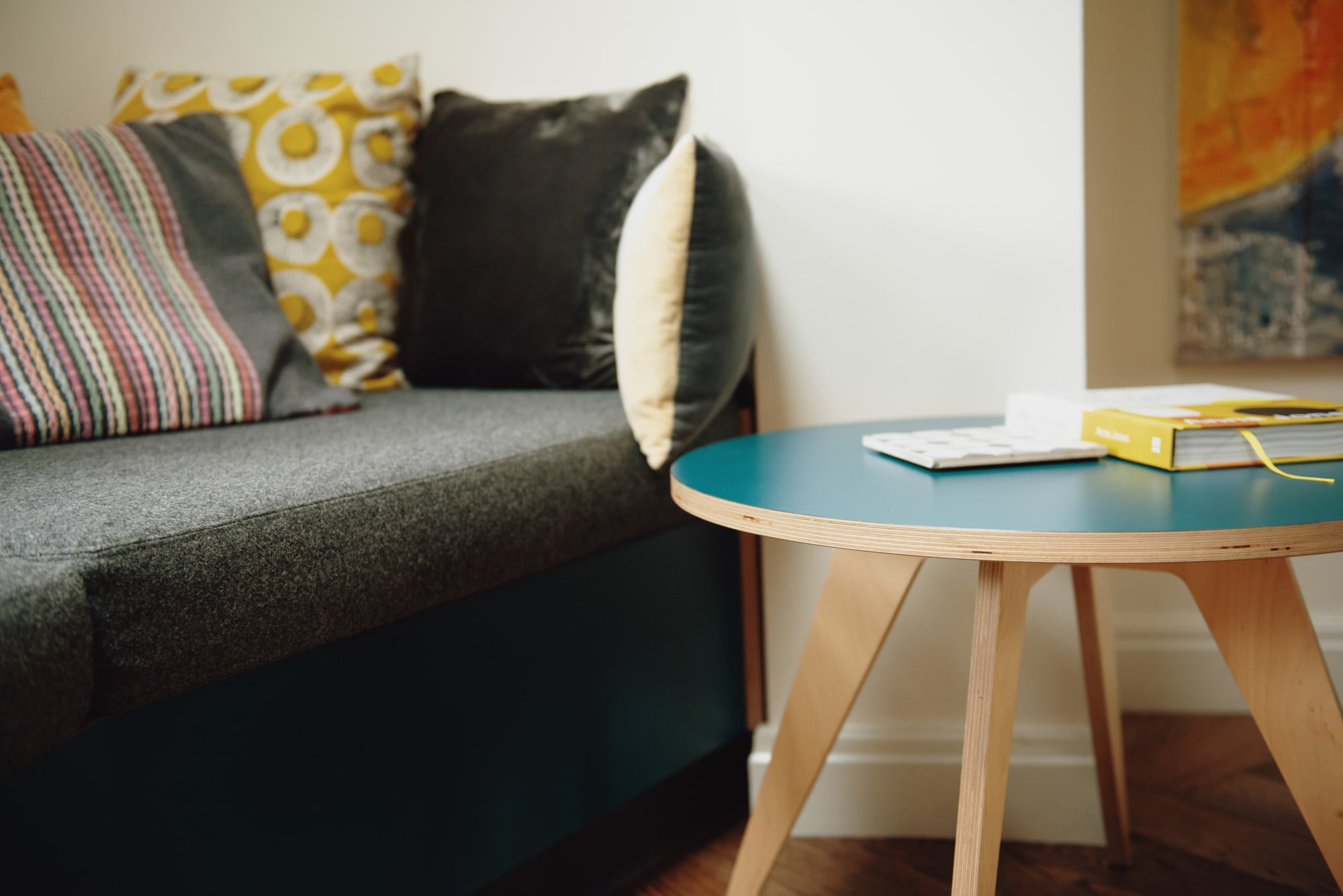 close up of upholstered window seat and table