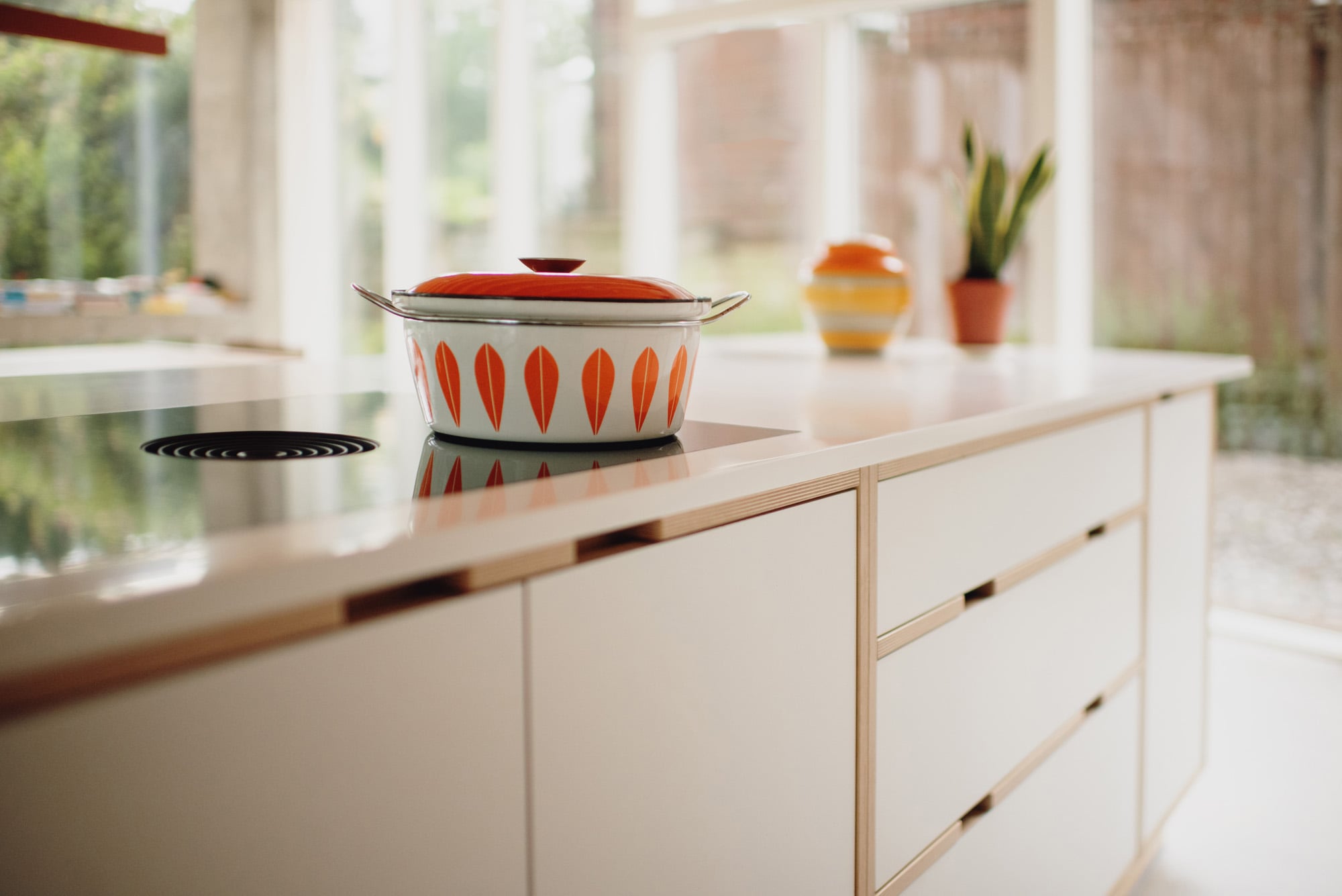 Bora hob with retro pot on white plywood kitchen island 