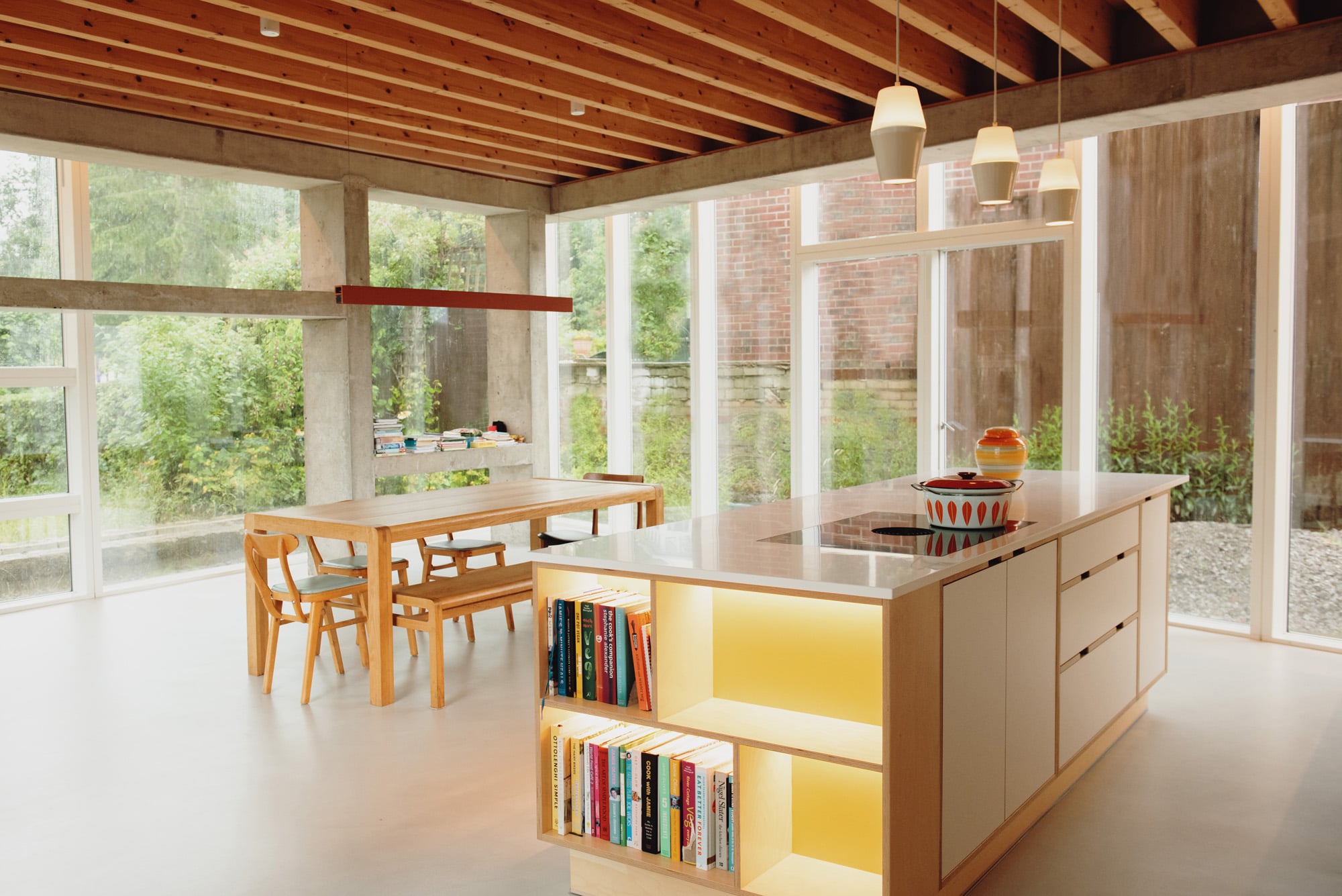 illuminated yellow and white island unit in open plan kitchen