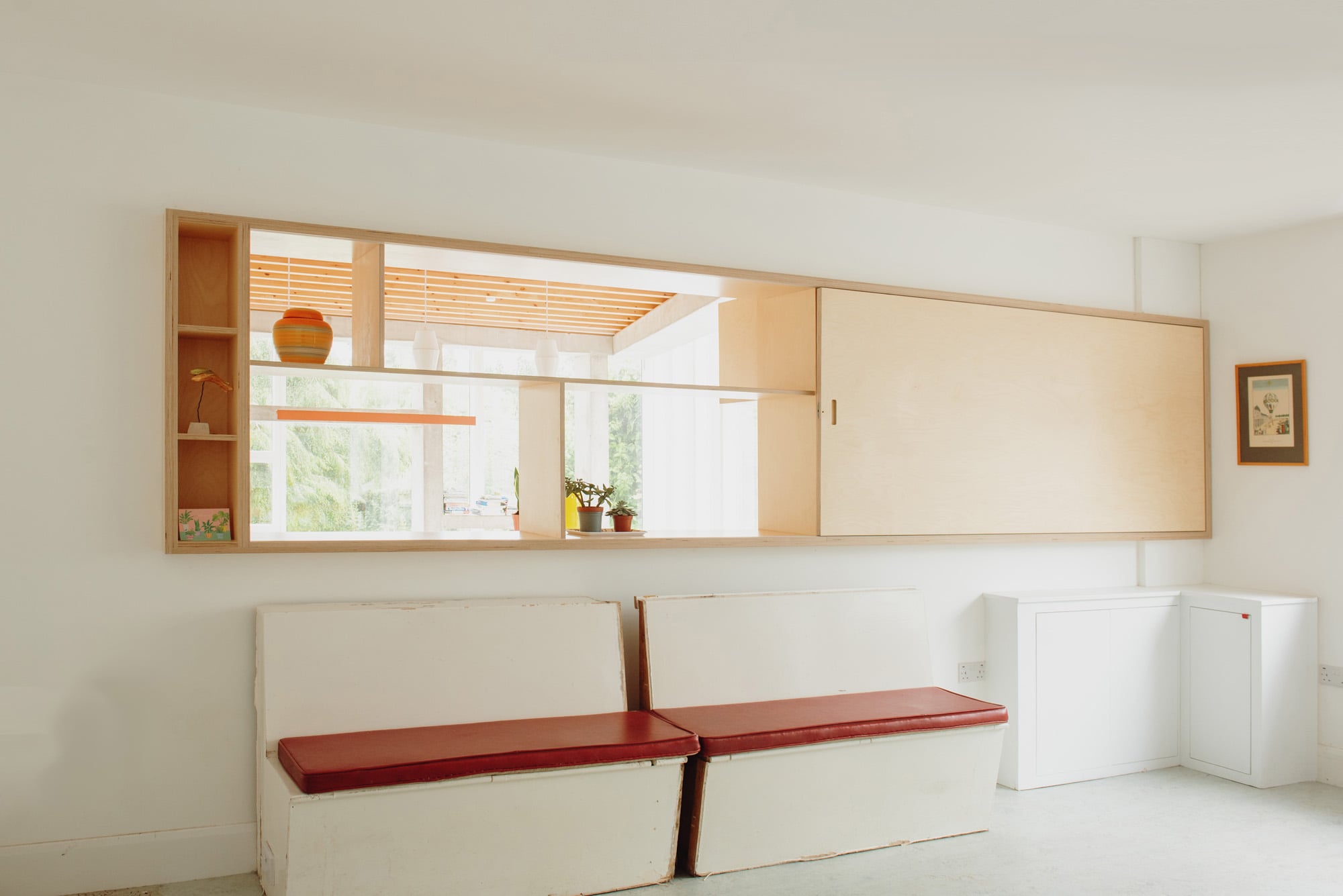 retro bench seating in room with opening in wall 