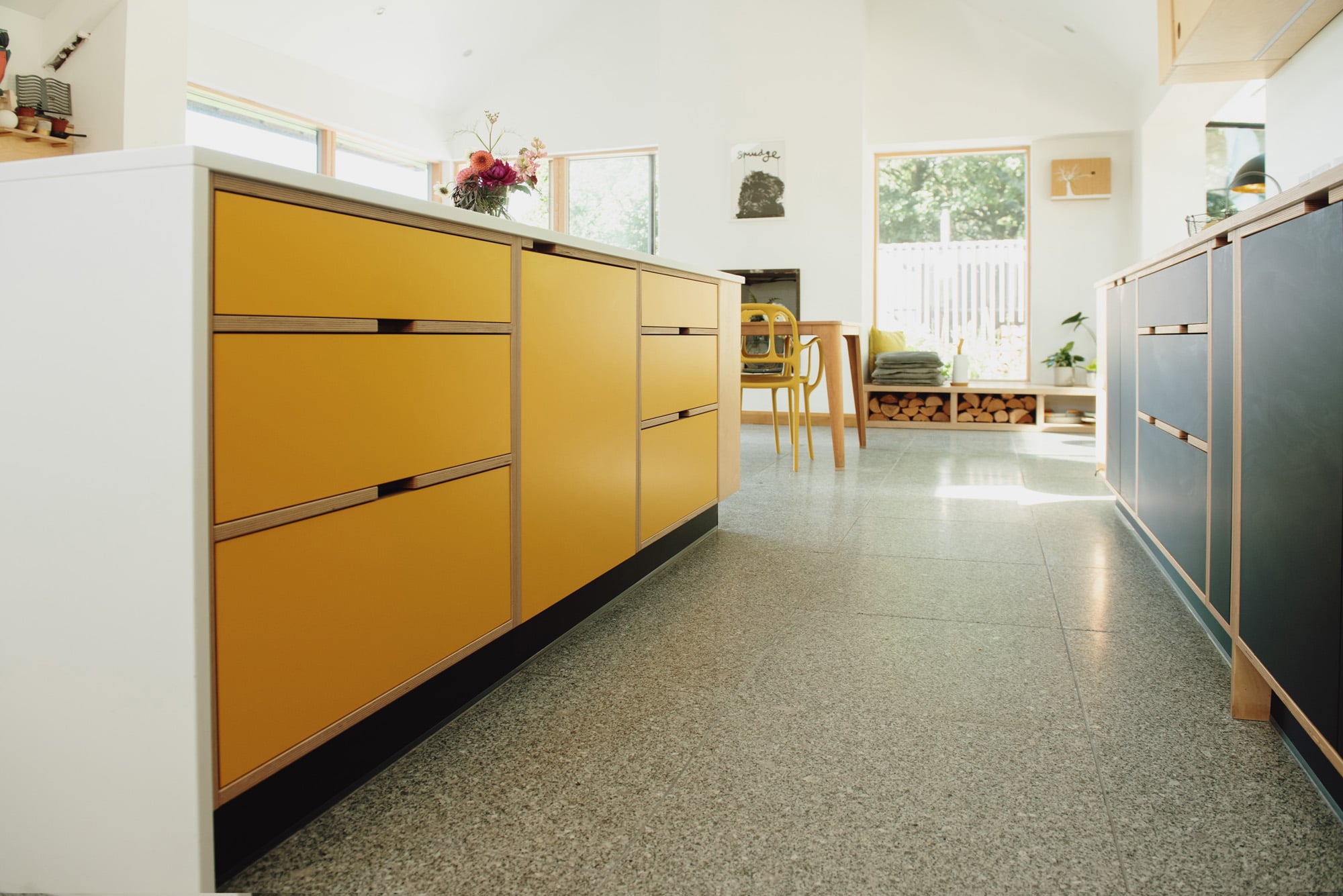 yellow plywood island with corian waterfall sides 