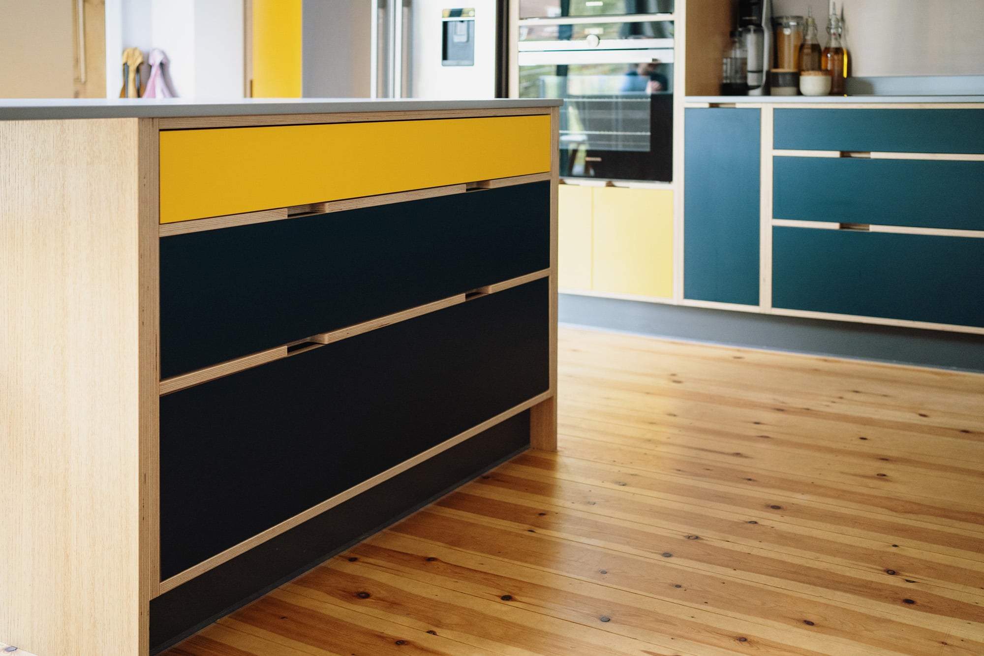 kitchen island with yellow and black drawers
