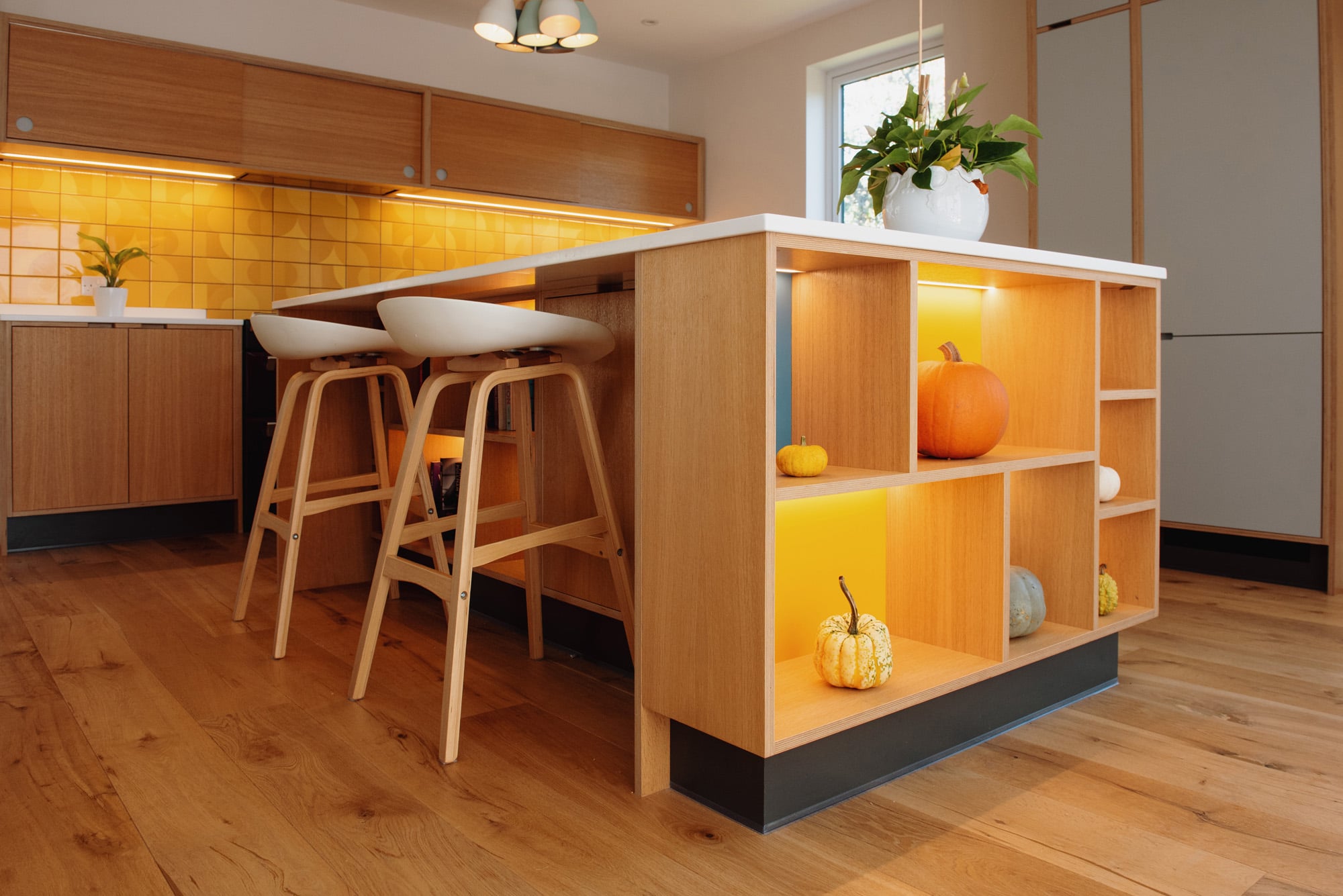 oak veneered island unit with yellow open shelving