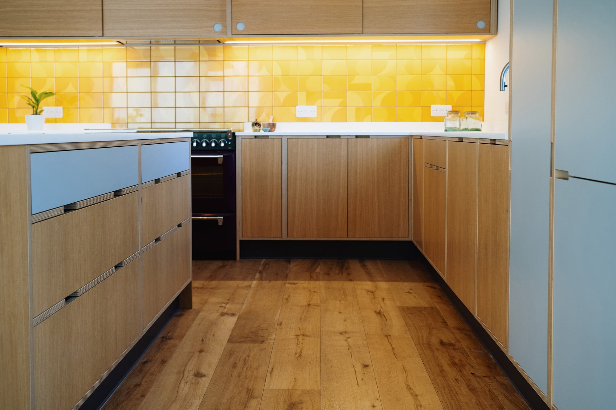 Oak Veneer and Laminate Kitchen with Yellow Illuminated Tiles