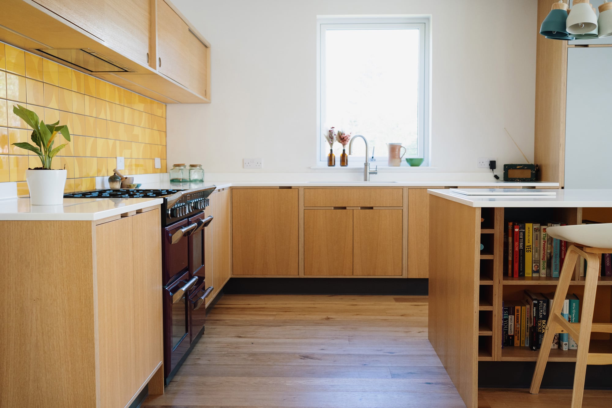 Oak veneer kitchen sink unit under window