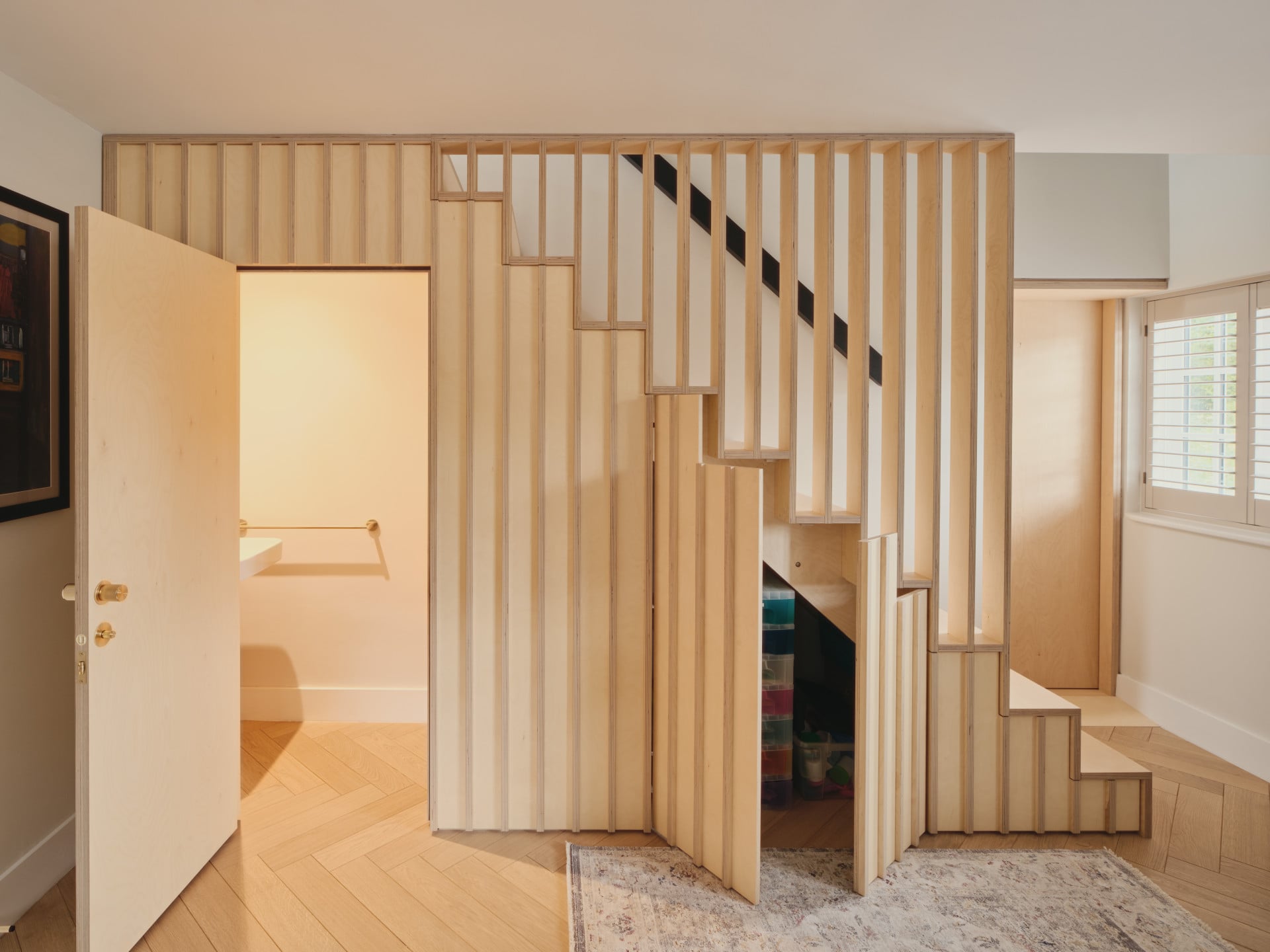 staircase with under stairs storage doors open