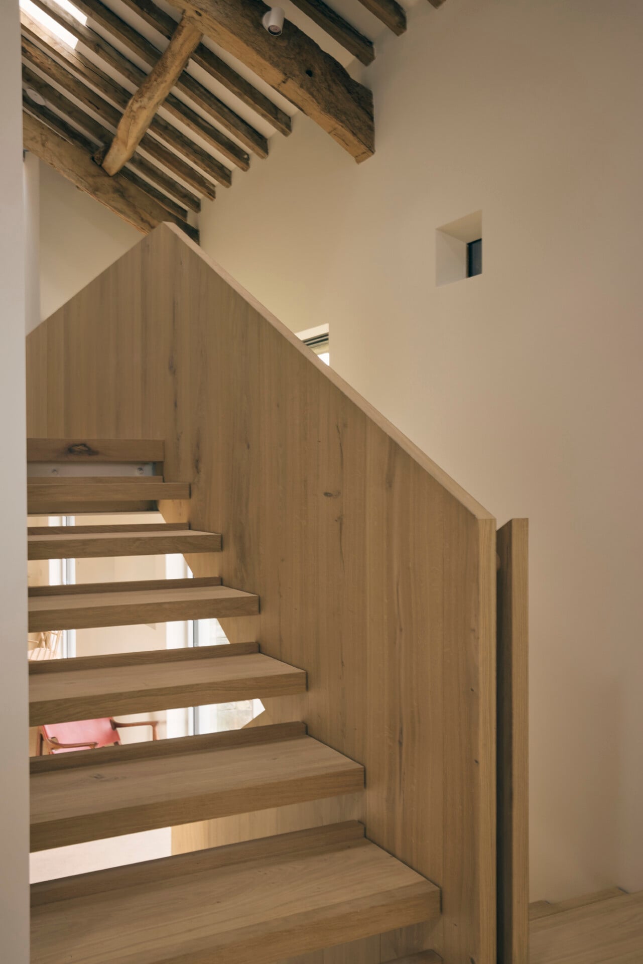 Floating staircase in barn conversion with oak treads and hidden stringers