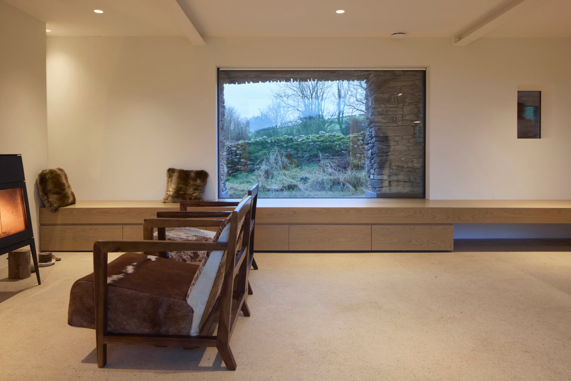 Barn living space with built-in window bench and countryside views
