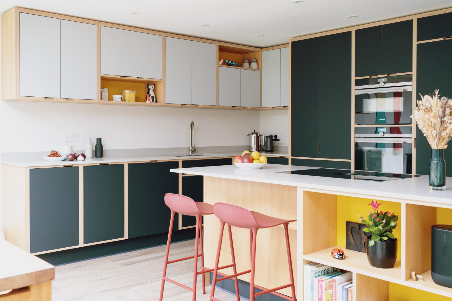 Handleless plywood kitchen with contrasting light uppers and dark lower cabinets