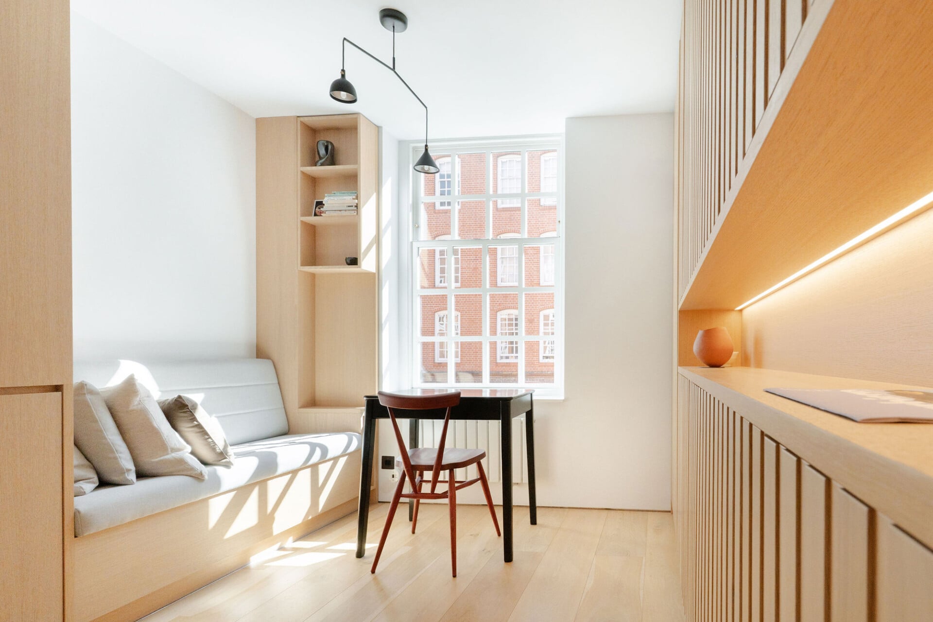 Study nook with built-in oak desk, shelving and slatted feature wall