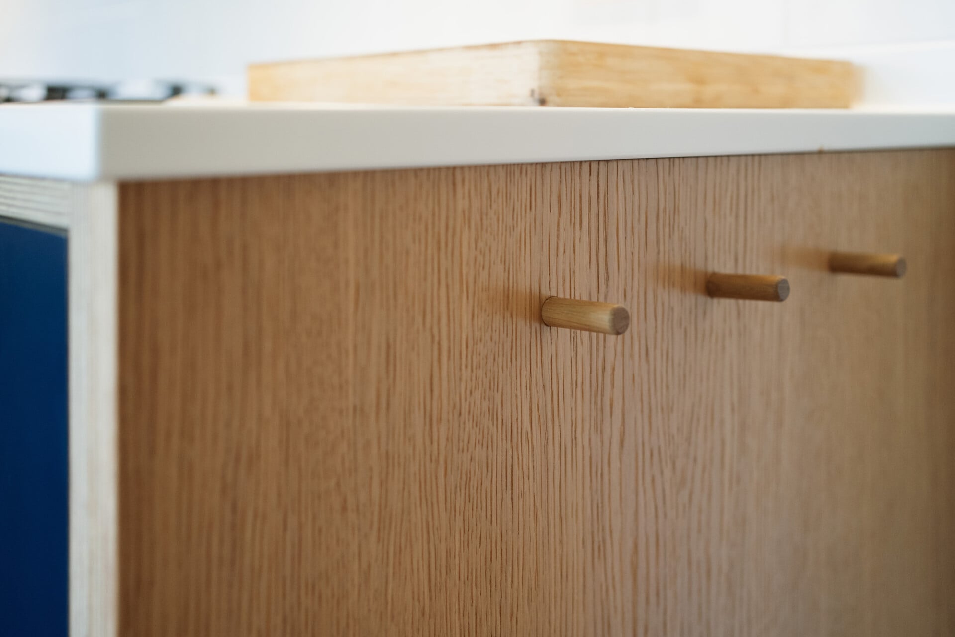 Close-up of oak cupboard detail with minimalist wooden handles