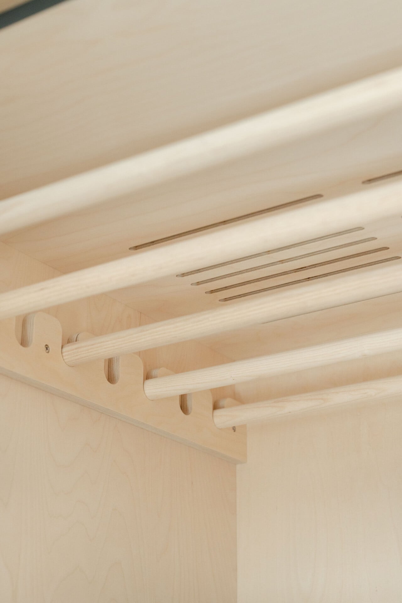 Timber slatted ceiling detail viewed from below with inset lighting