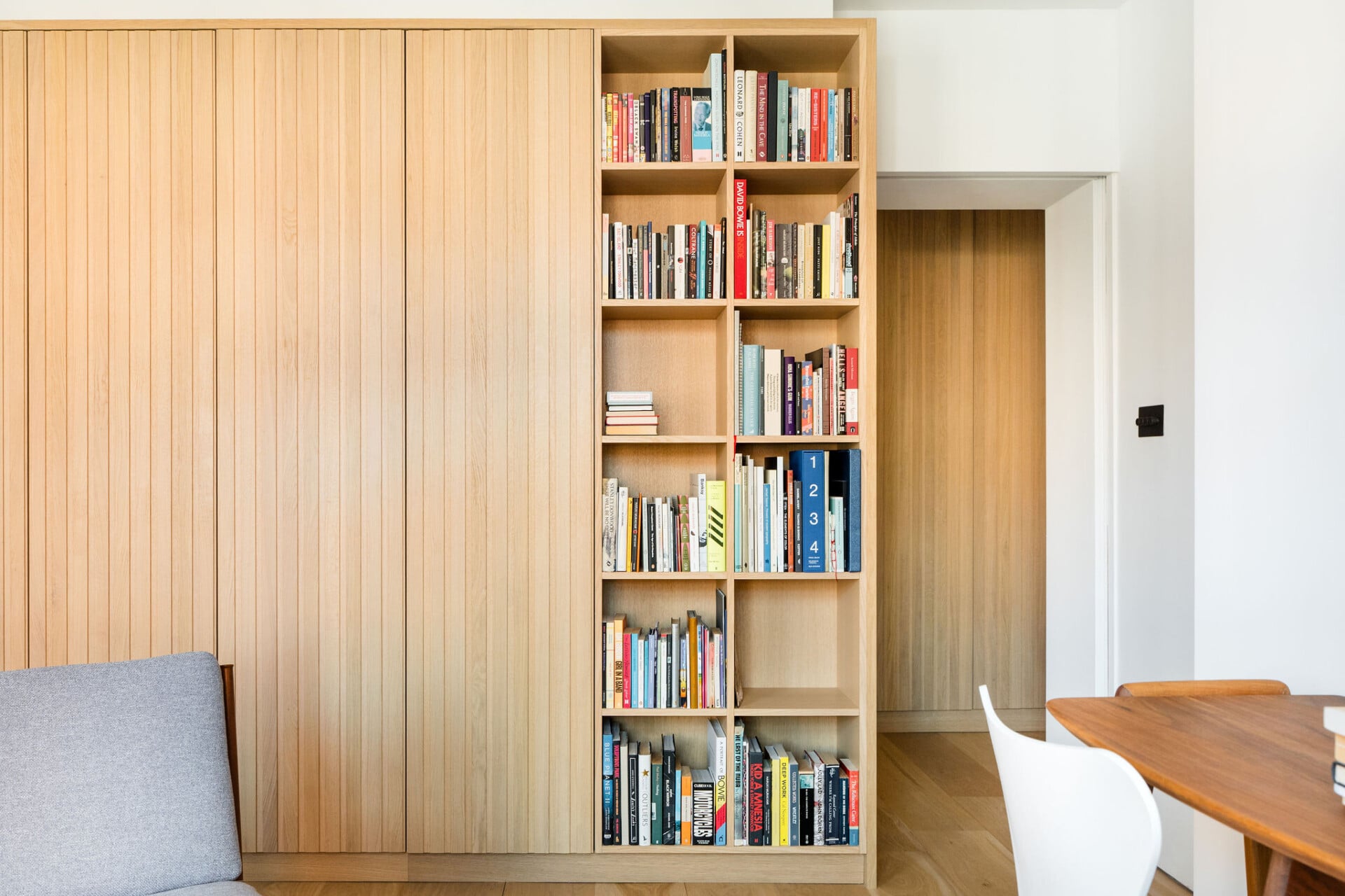 Tall plywood bookcase with floor to ceiling storage