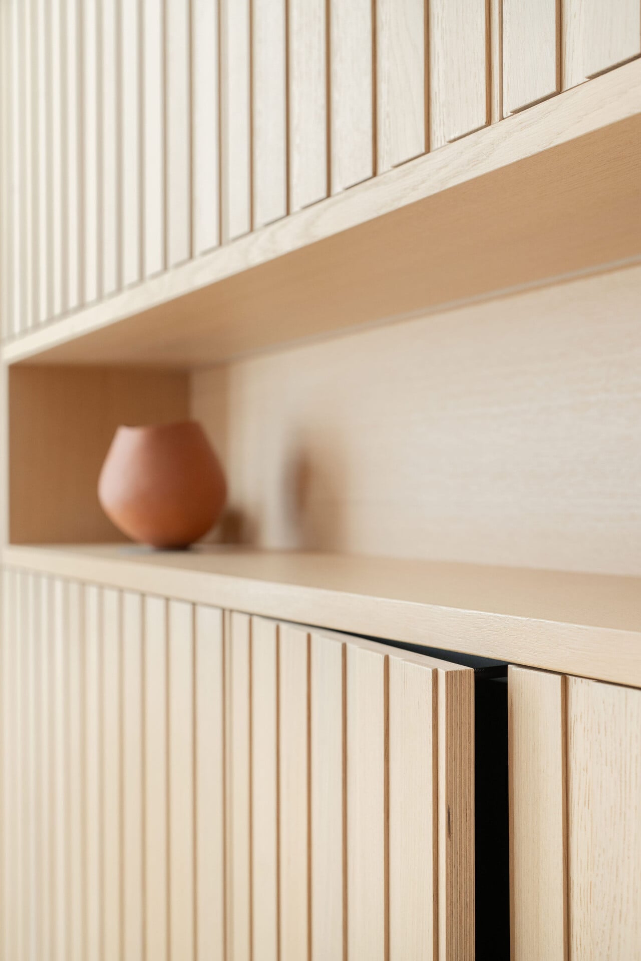 Detail of storage wall with concealed openings