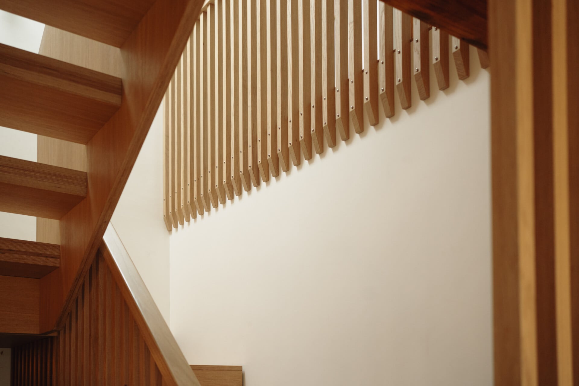 Staircase balustrade with vertical slatted plywood screen